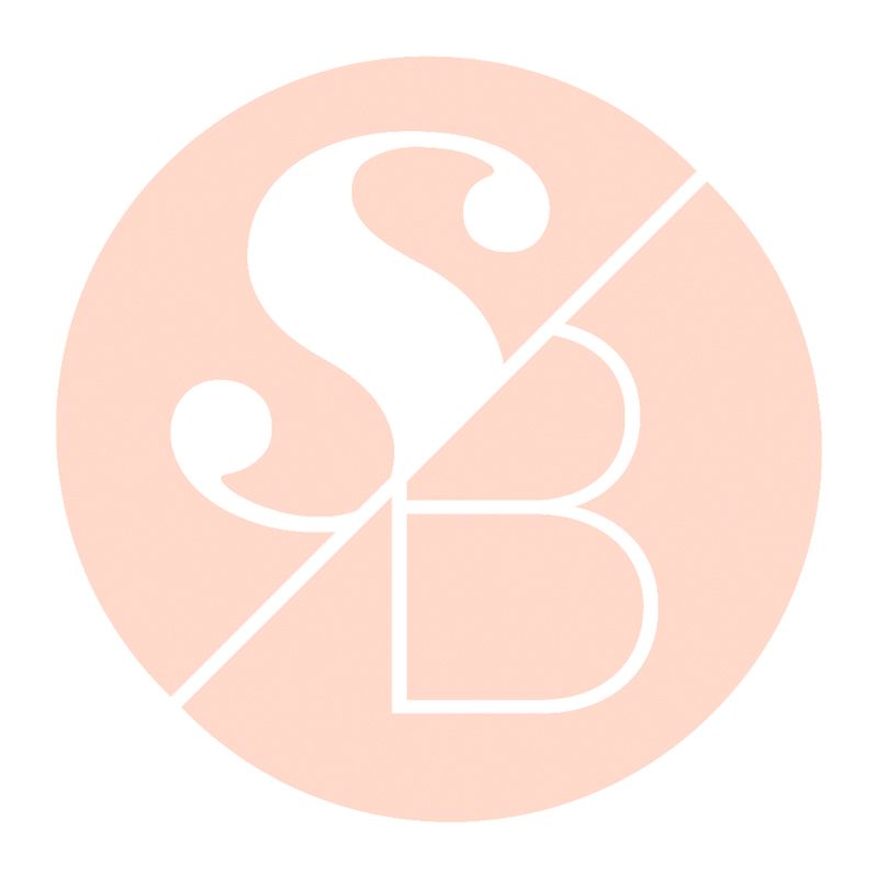 A minimalist monogram logo design featuring letters S and B in white against a soft peach-colored circular background.