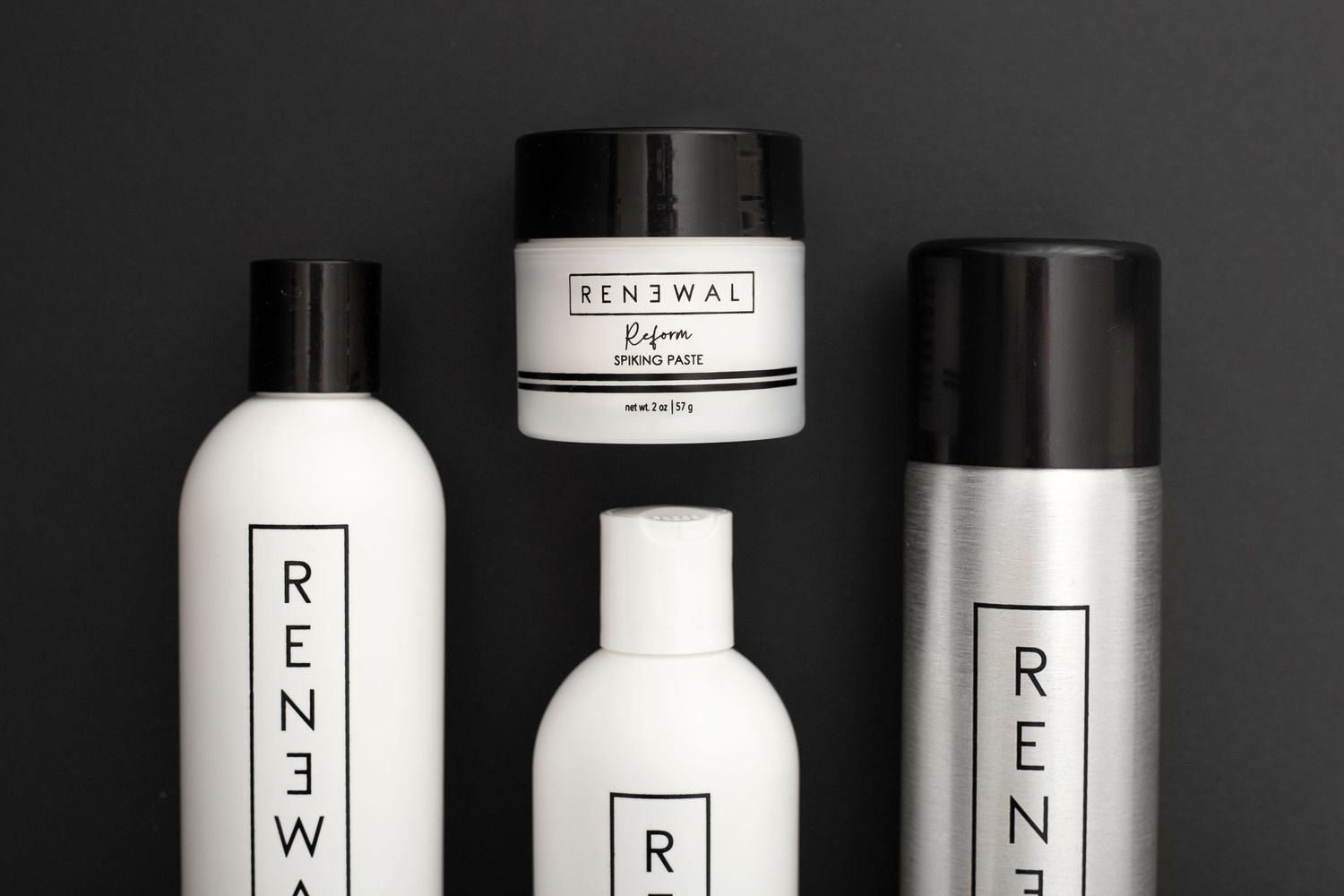 Renewal brand skincare and haircare products displayed on dark background.