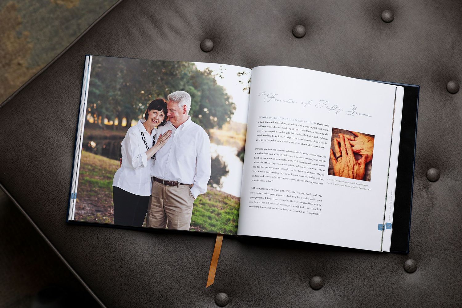 Open family memory book showing couple portrait photo and personal story text on leather surface.