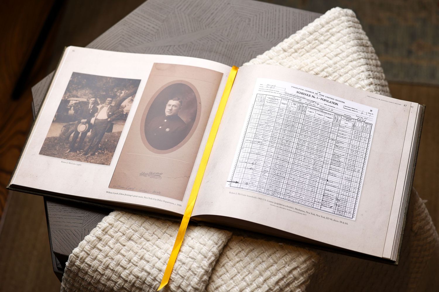 Open genealogy book displaying vintage family photographs and handwritten census records.