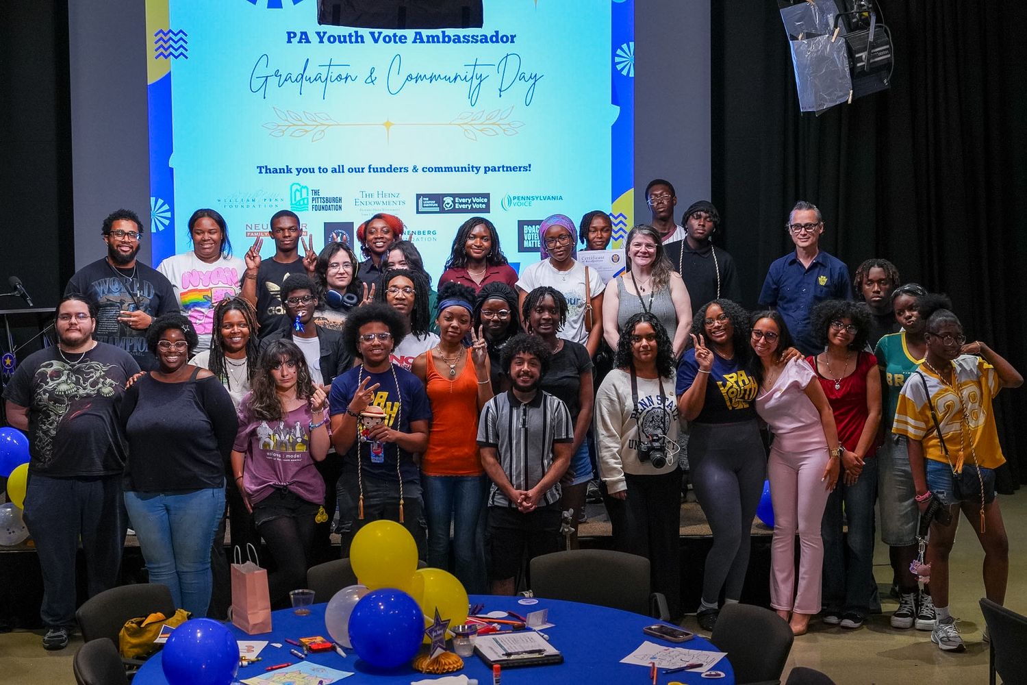 Large group photo at PA Youth Vote Ambassador Graduation and Community Day event with blue and gold decorations.
