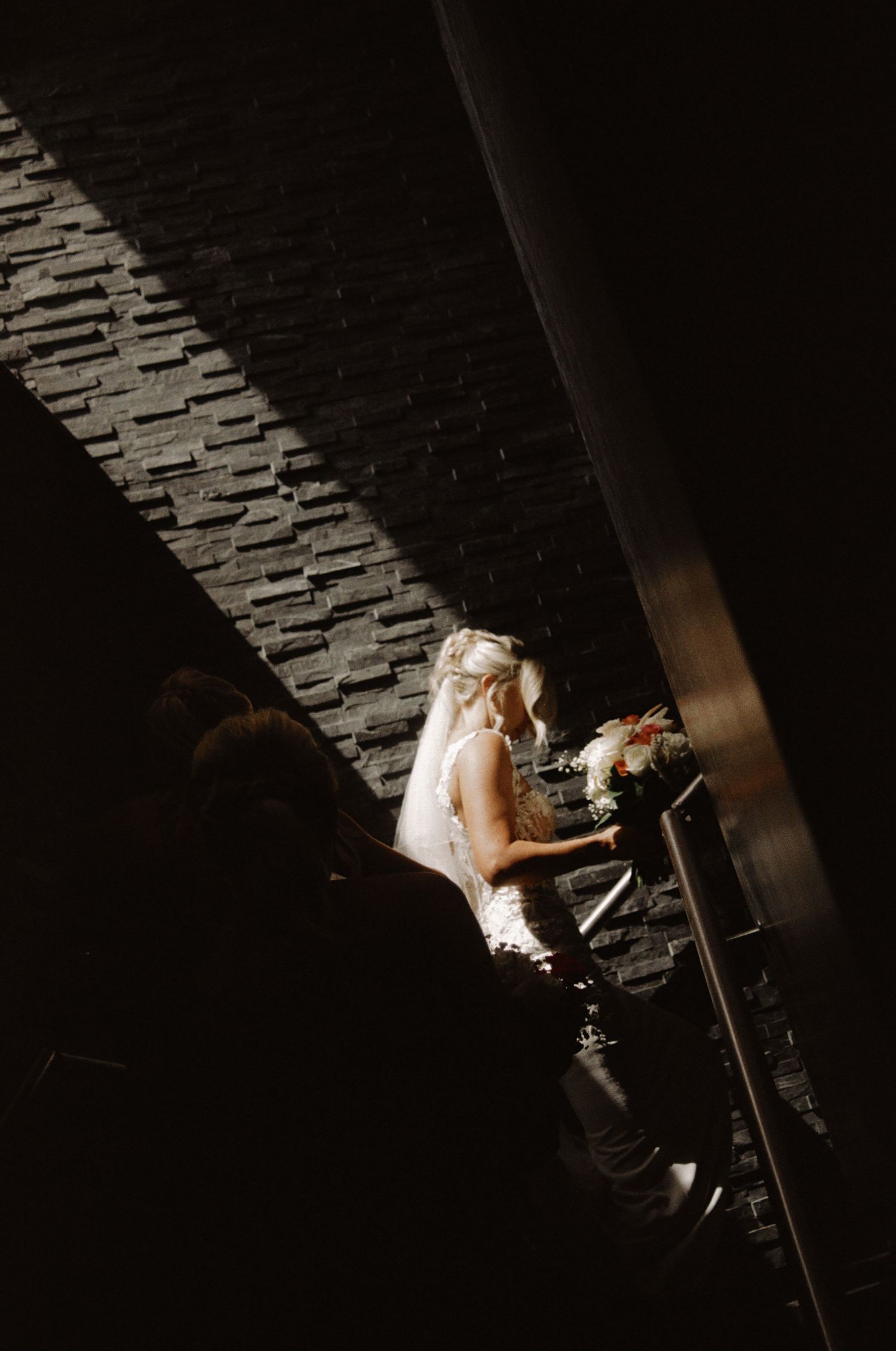 Dramatic overhead shot of a wedding dress in dark lighting.
