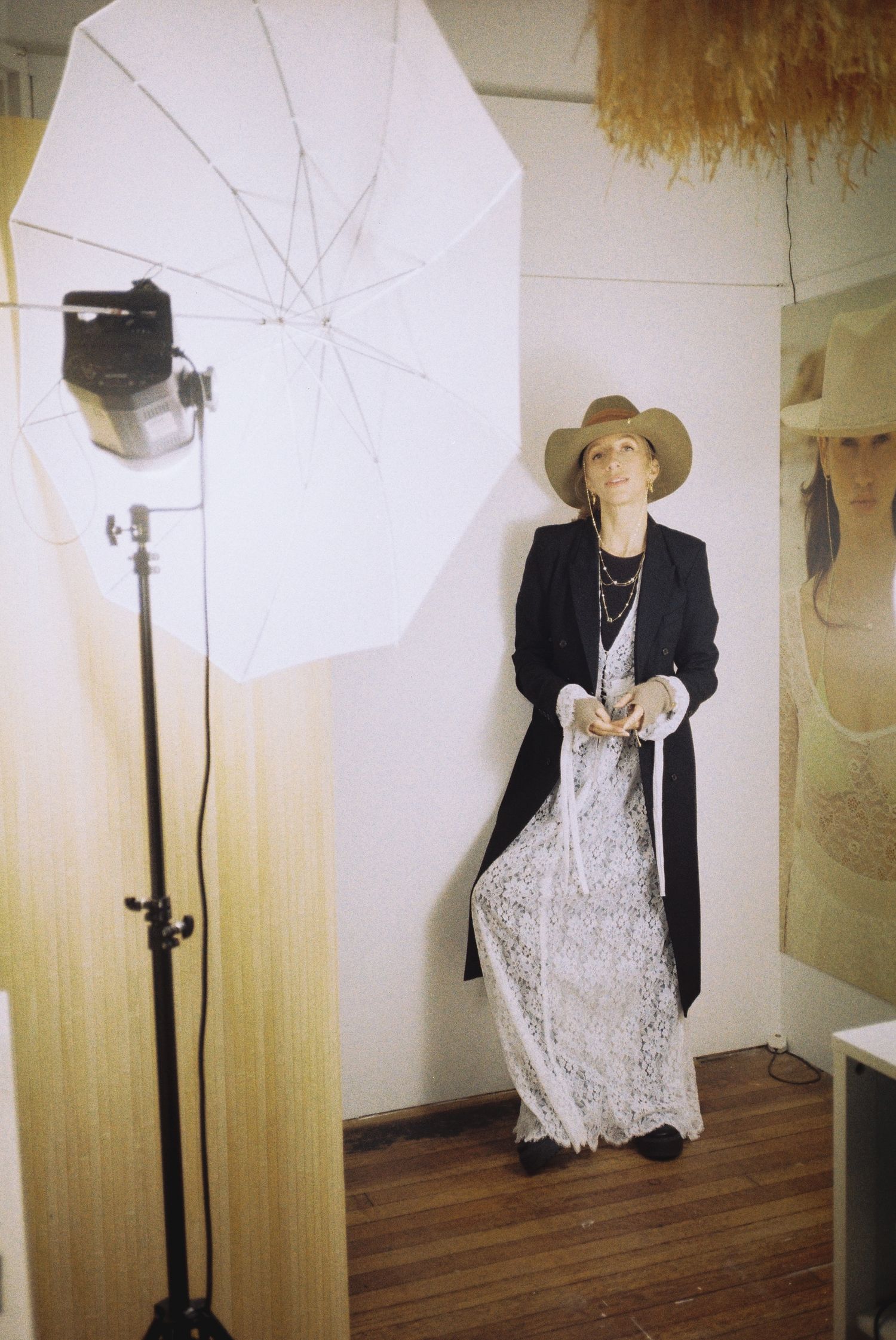 Fashion display with black blazer and white lace dress on mannequin in studio setting.