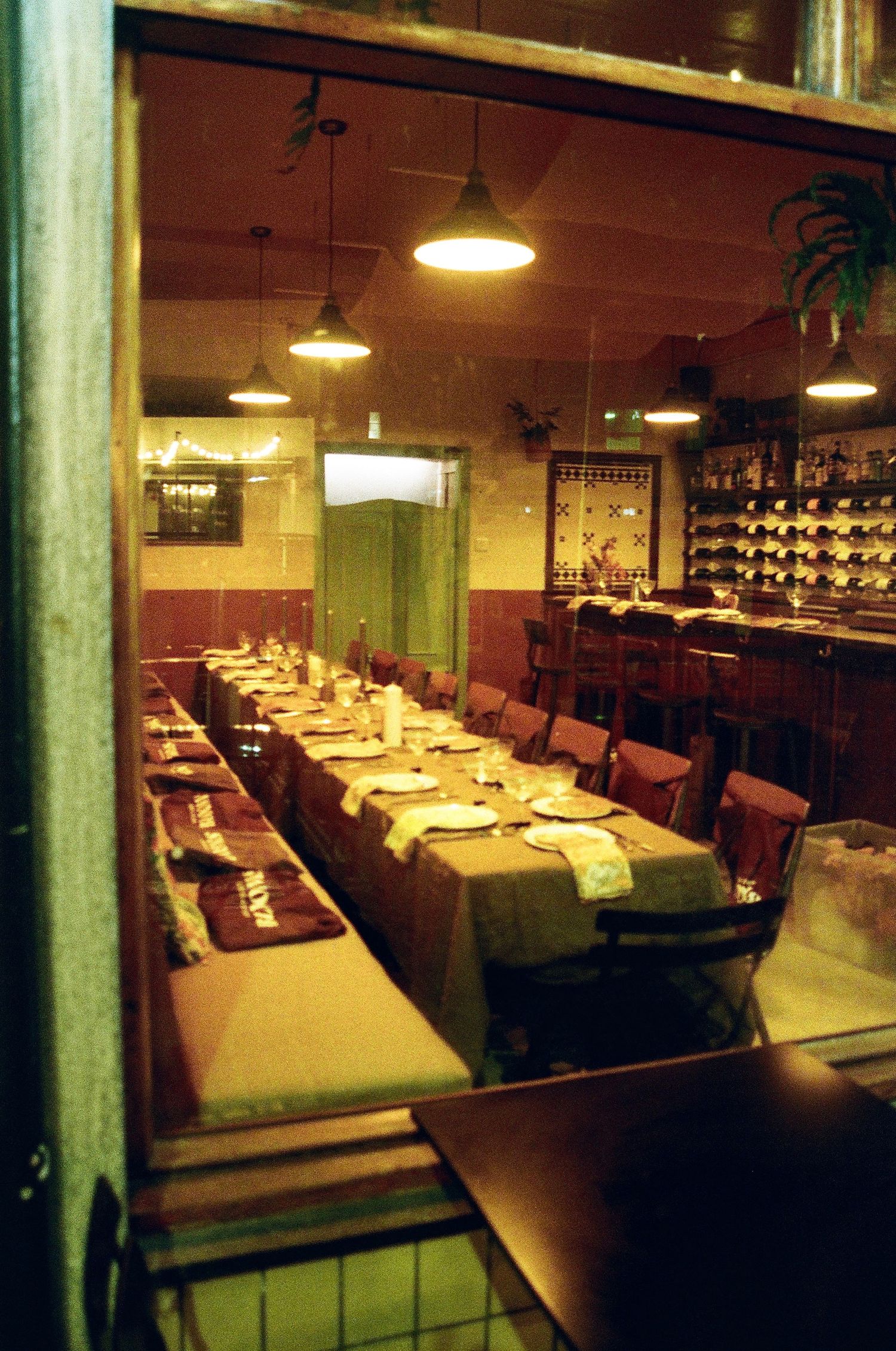 Interior view of an empty restaurant dining room with tables set and ambient lighting.