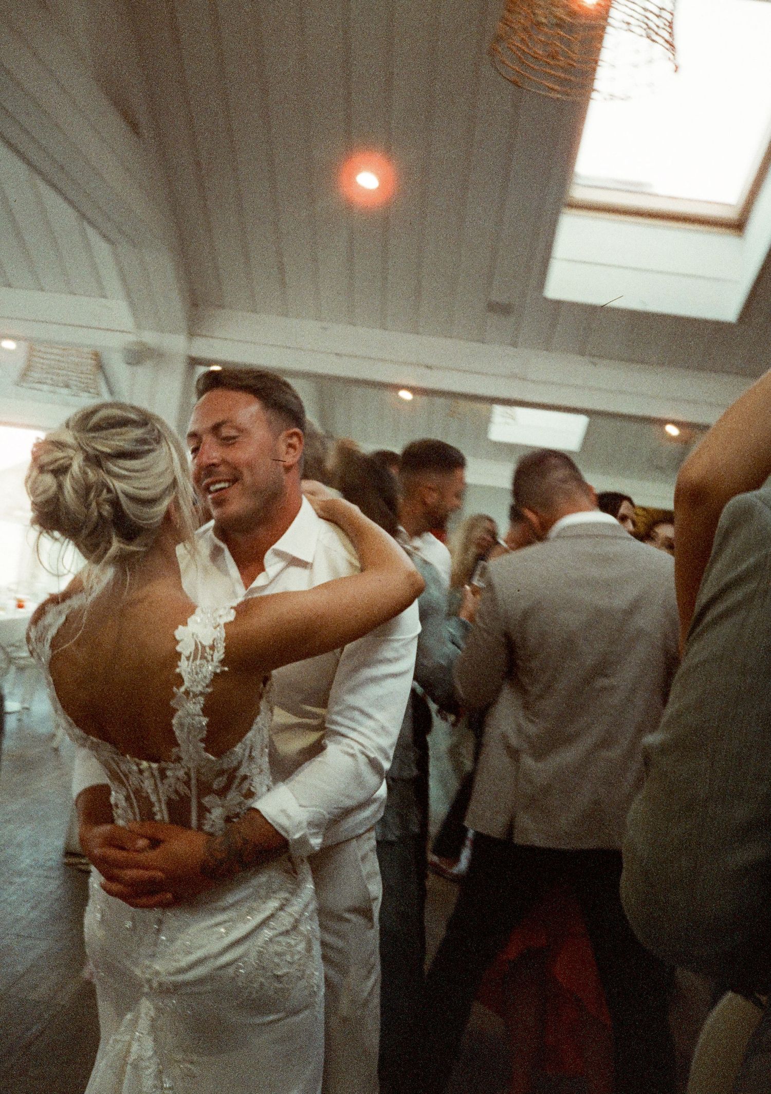 Wedding reception dance floor with couples dancing in formal attire.