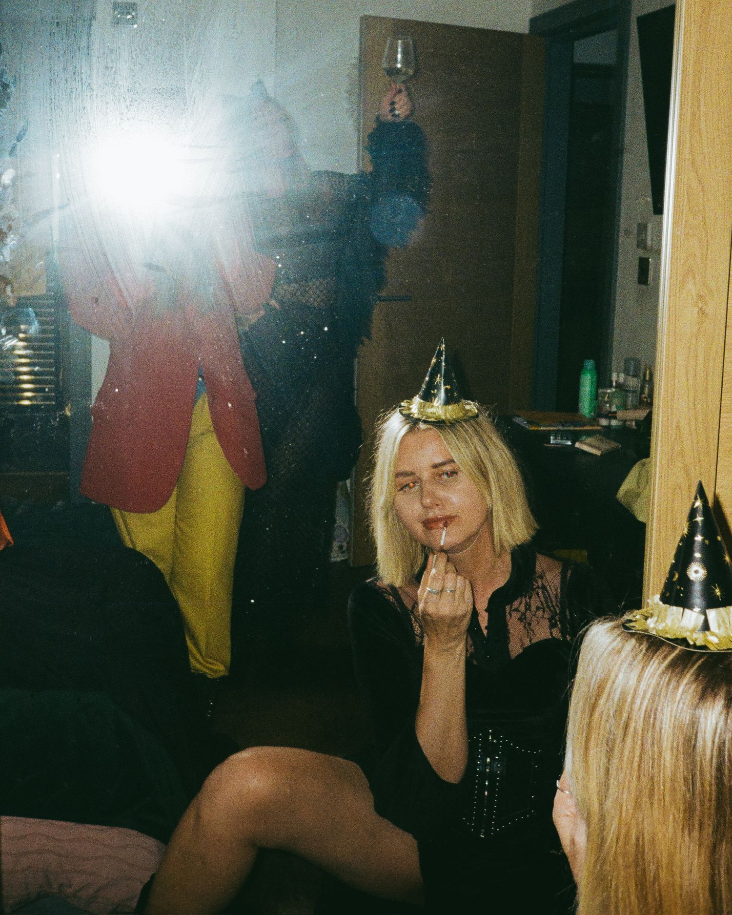 Party scene with flashing camera lights and celebratory decorations.