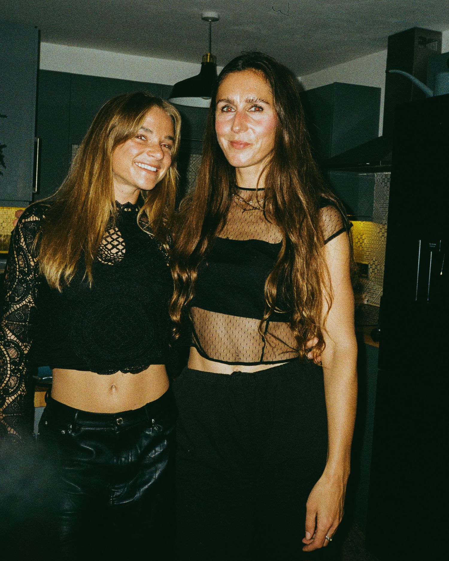 Group enjoying a night out in dark party outfits with mesh details.