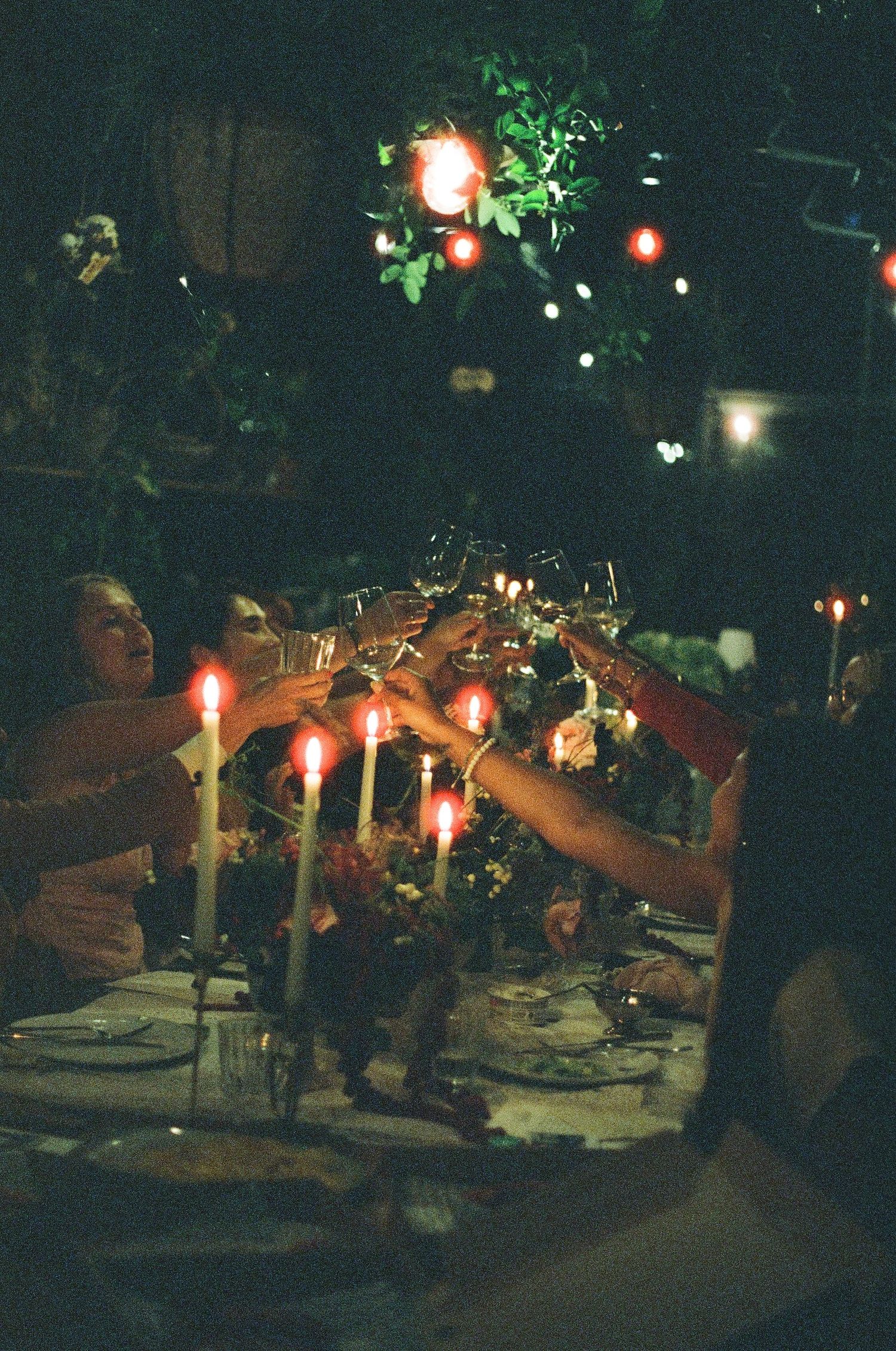 Candlelit dinner table with glowing ambient lighting and floral centerpieces.