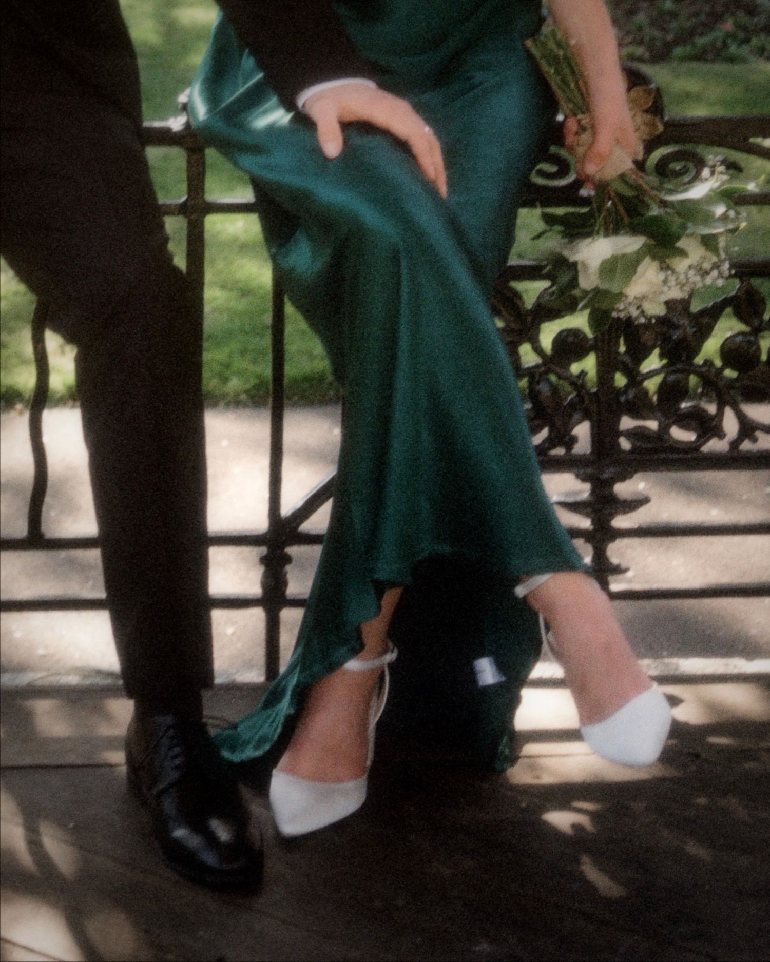 Close-up details of formal footwear and flowing fabric during an elegant dance.