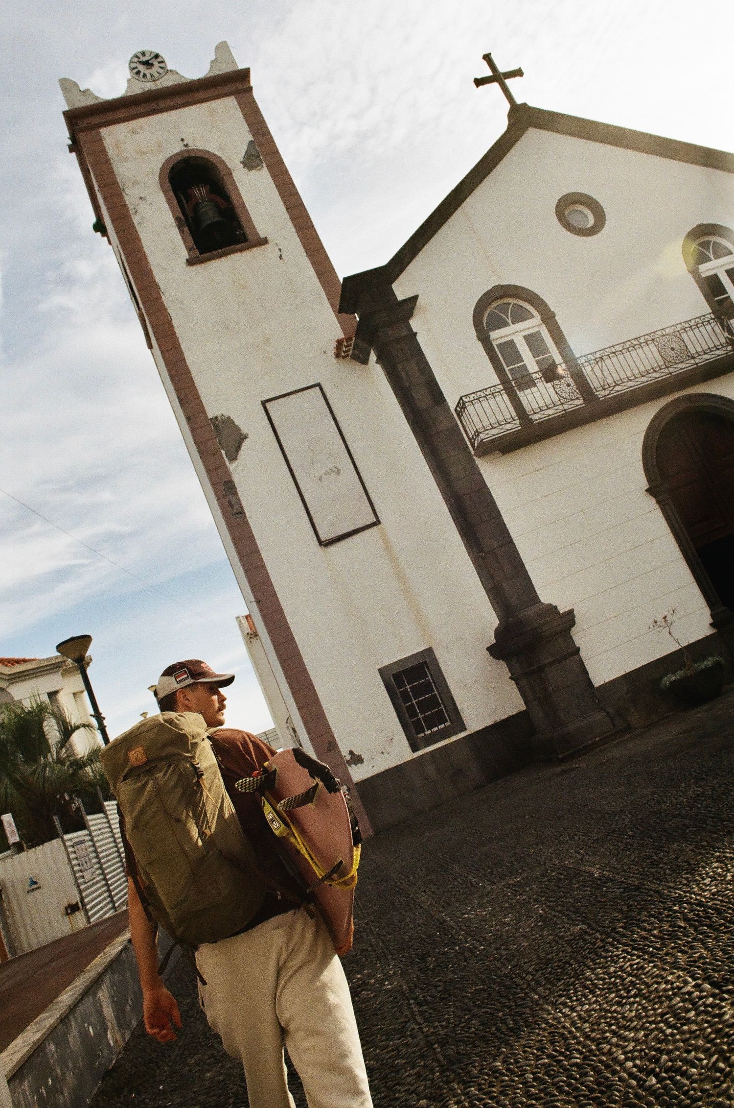 Historic white church exterior with cobblestone courtyard.