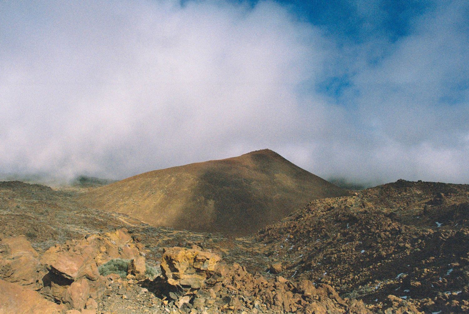 Panoramic view of rugged mountain landscape under partly cloudy skies.