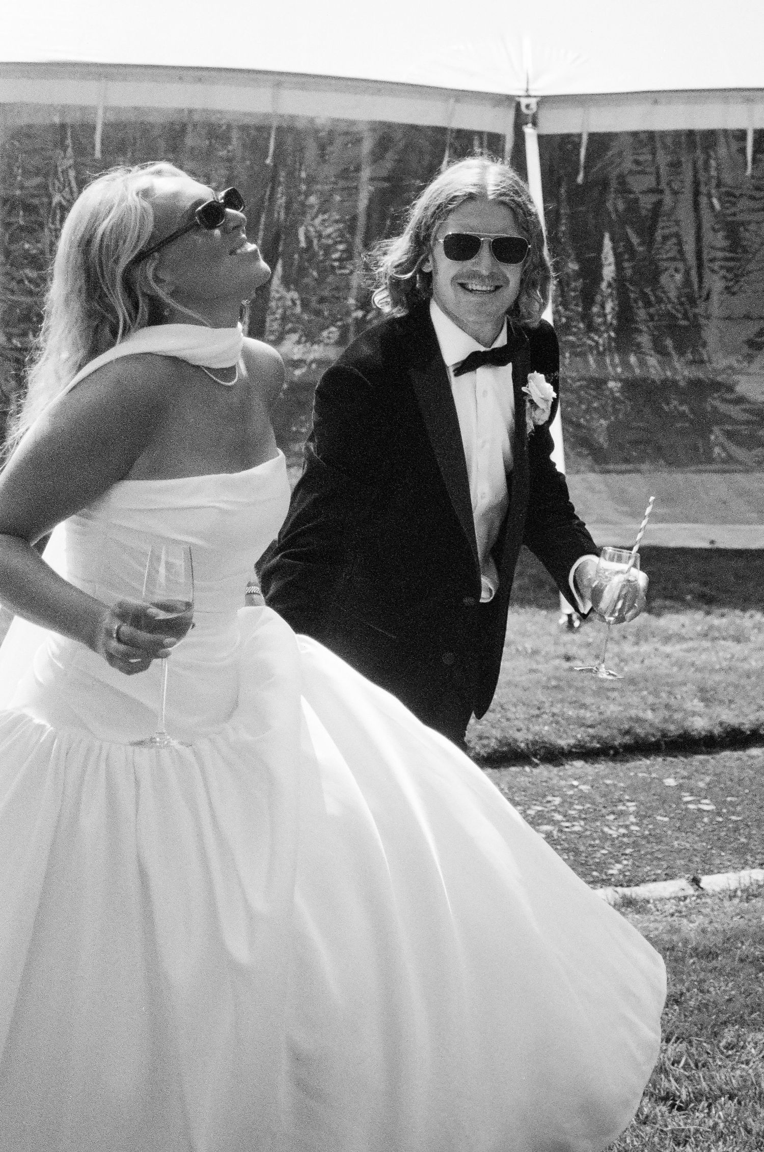 Playful sequence of white wedding dresses twirling in an outdoor garden setting.