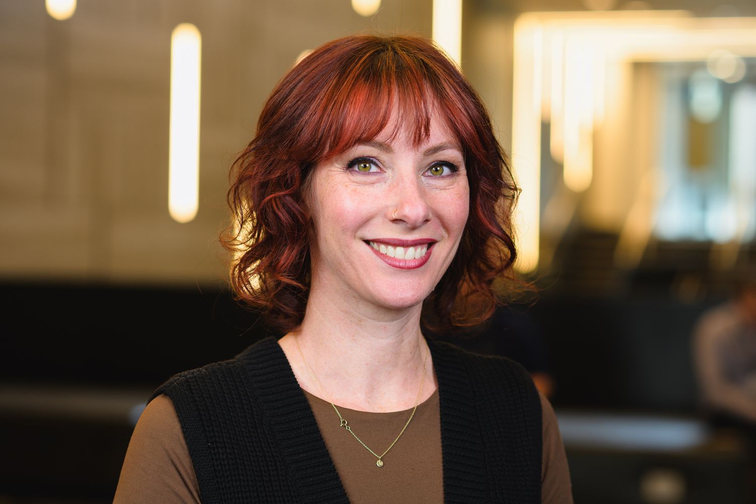 Professional portrait series showing warm expressions in office setting.