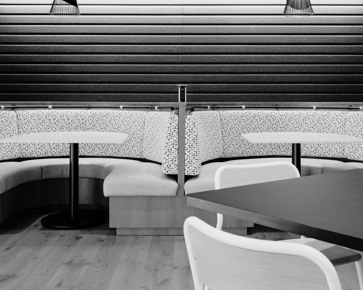 Sleek modern office interior with horizontal blinds and clean white furniture.