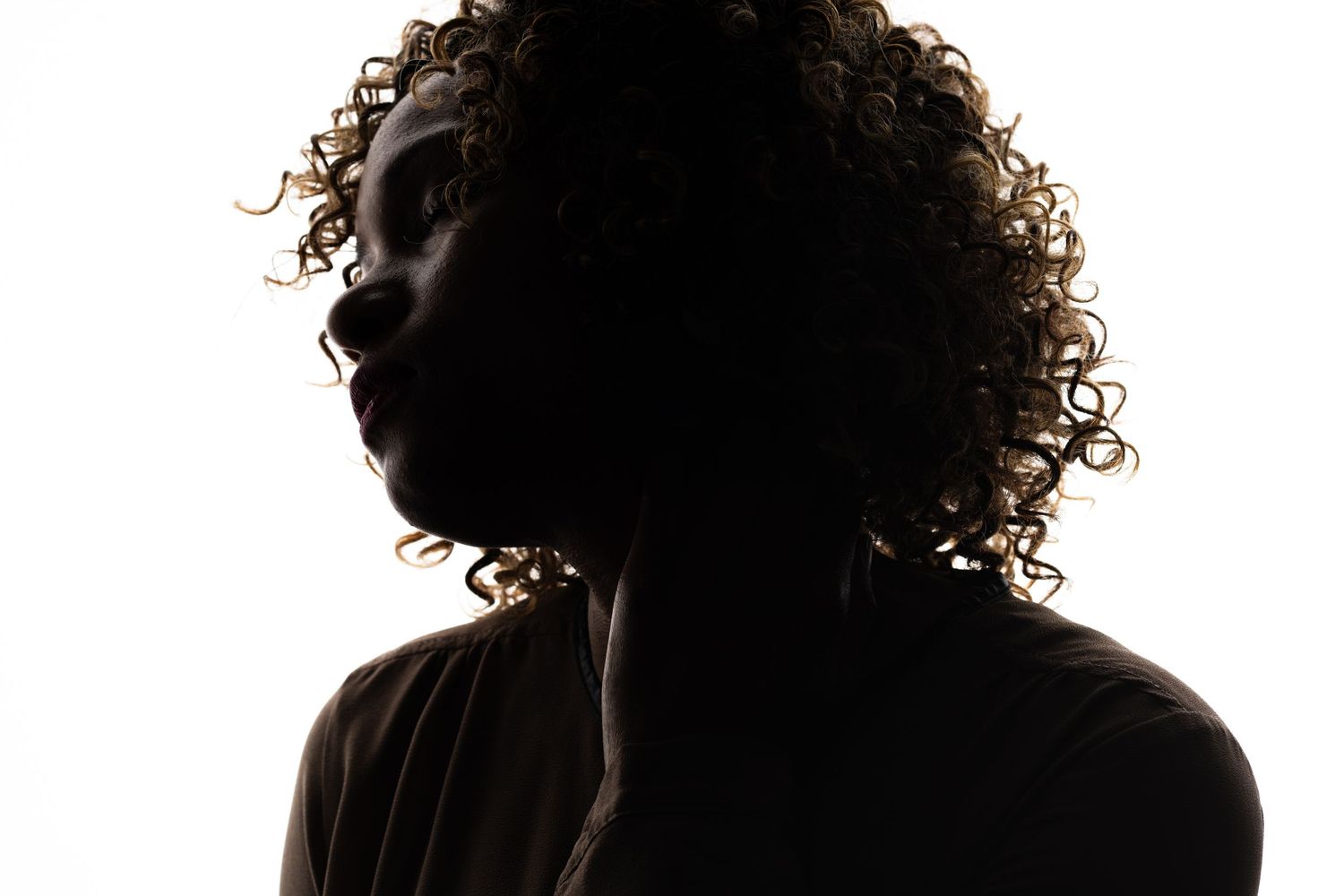 Series of silhouette portraits with curly hair against white backdrop.