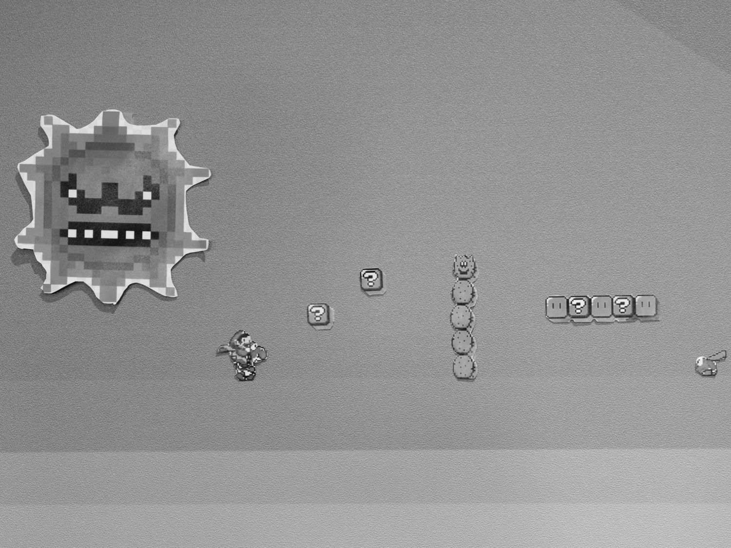 Minimalist white line art icons and symbols arranged in a row against a gray background.