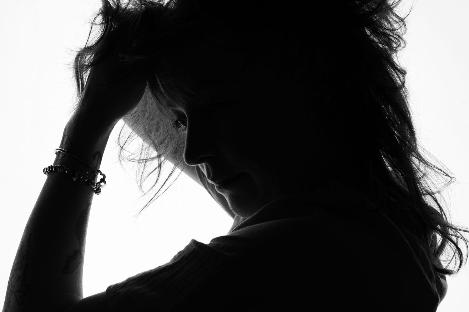Silhouetted figures in romantic poses against white background.