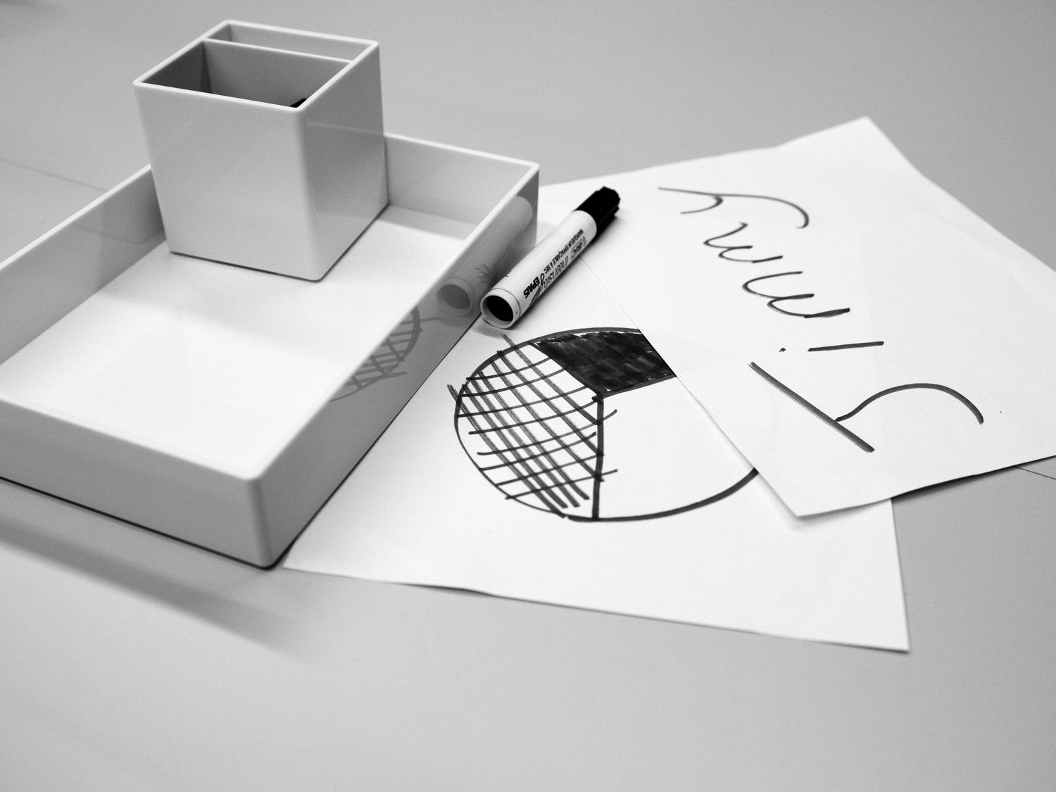 Series of white boxes and paper cutouts arranged in a minimal geometric composition on light background.
