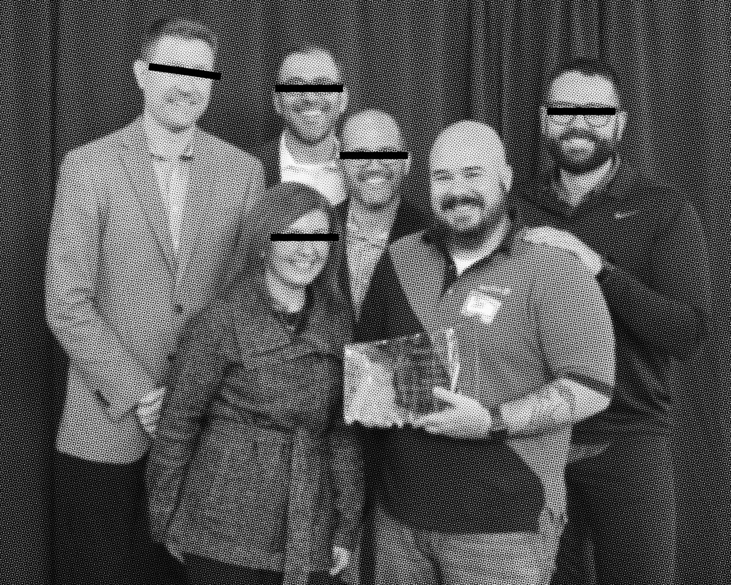 A group of people wearing casual attire stand together in a black and white photograph.