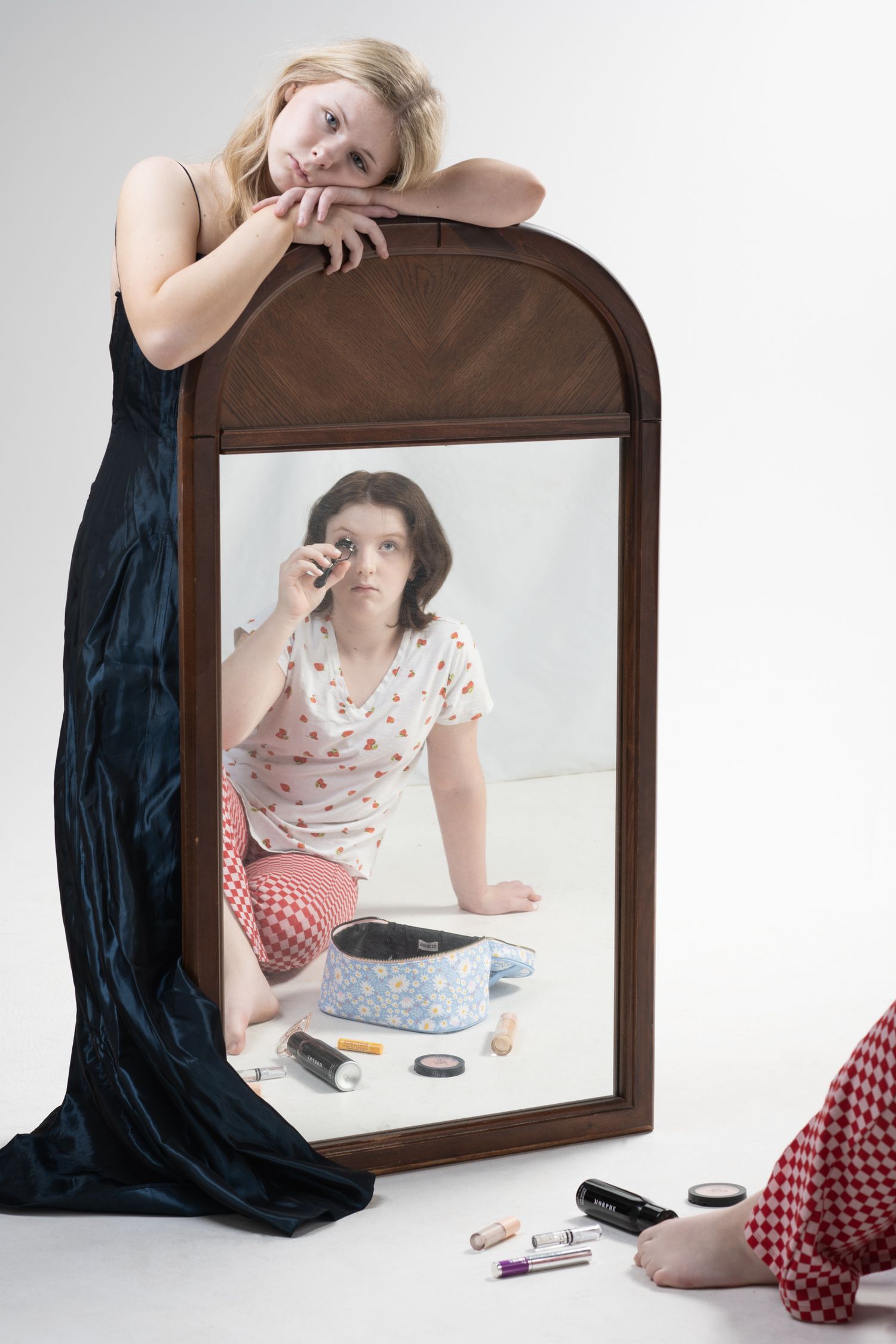 Creative mirror reflection photography setup with makeup and accessories.