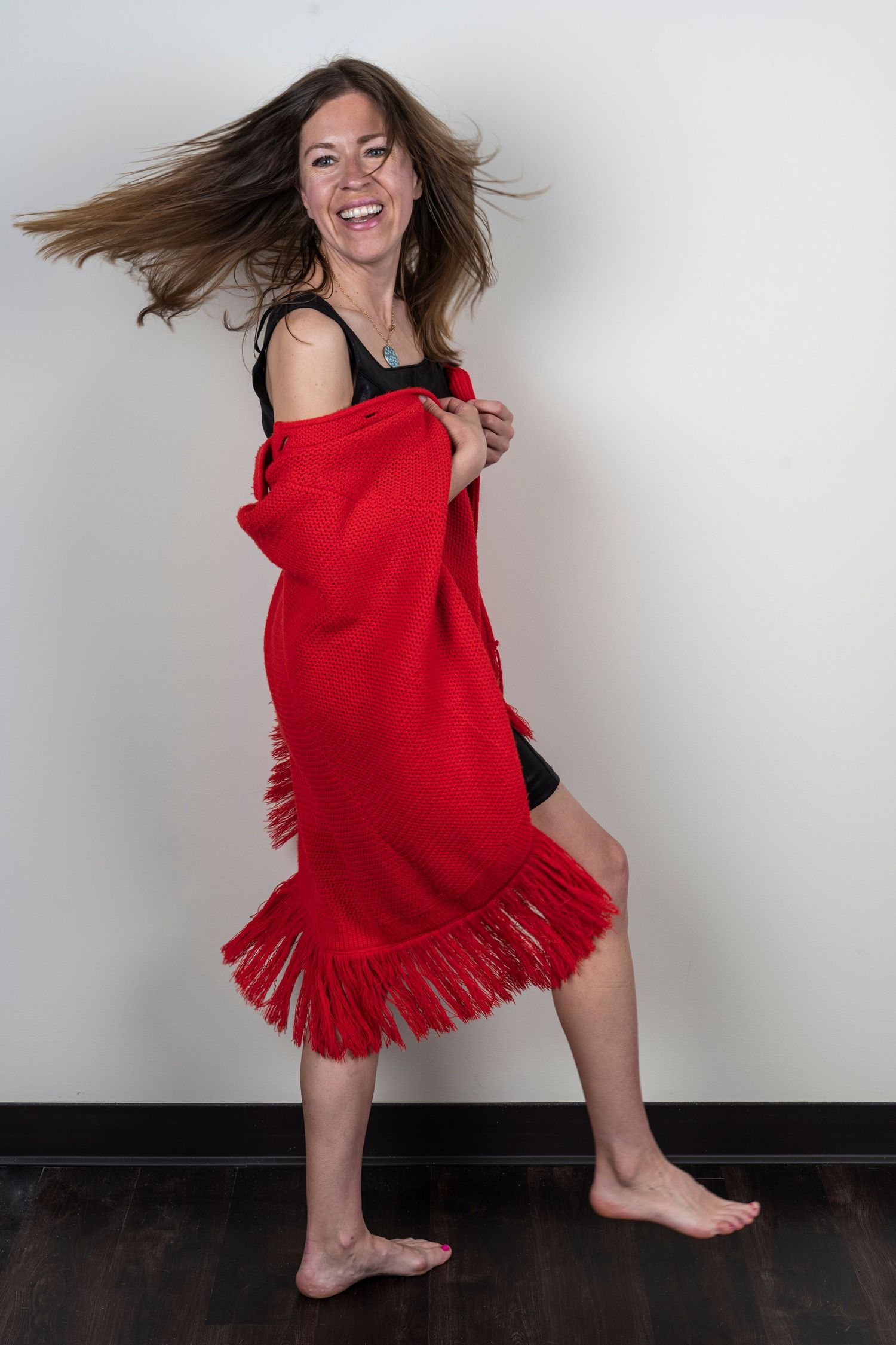 A dynamic dance sequence showing movement in a red dress against a light background.
