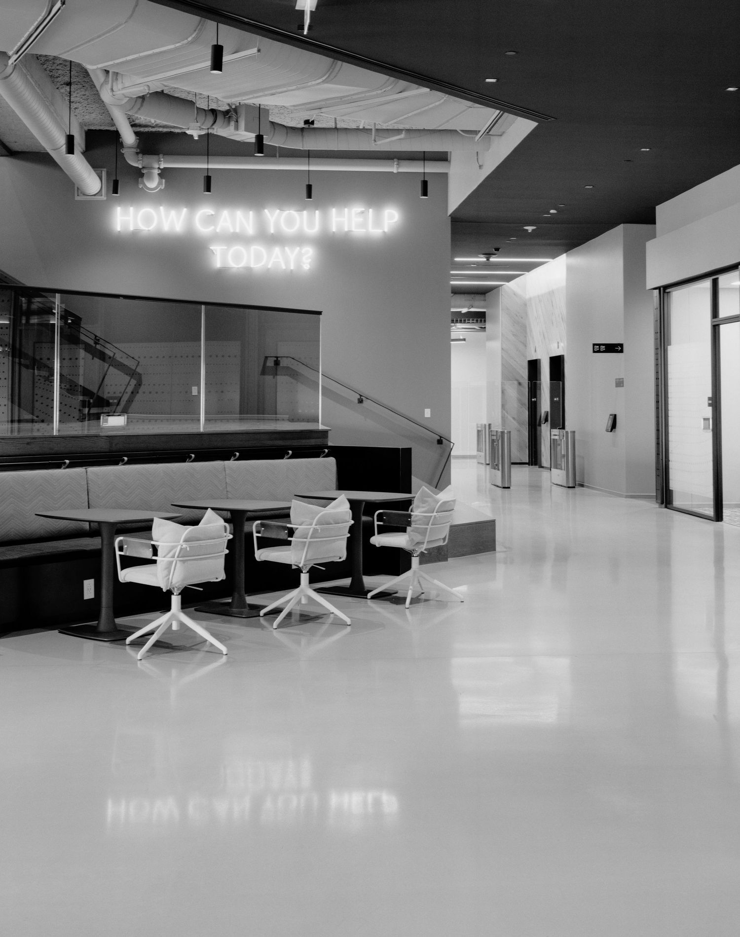 A series of minimalist black and white office interior photos showing modern workspaces with sleek furniture and lighting.