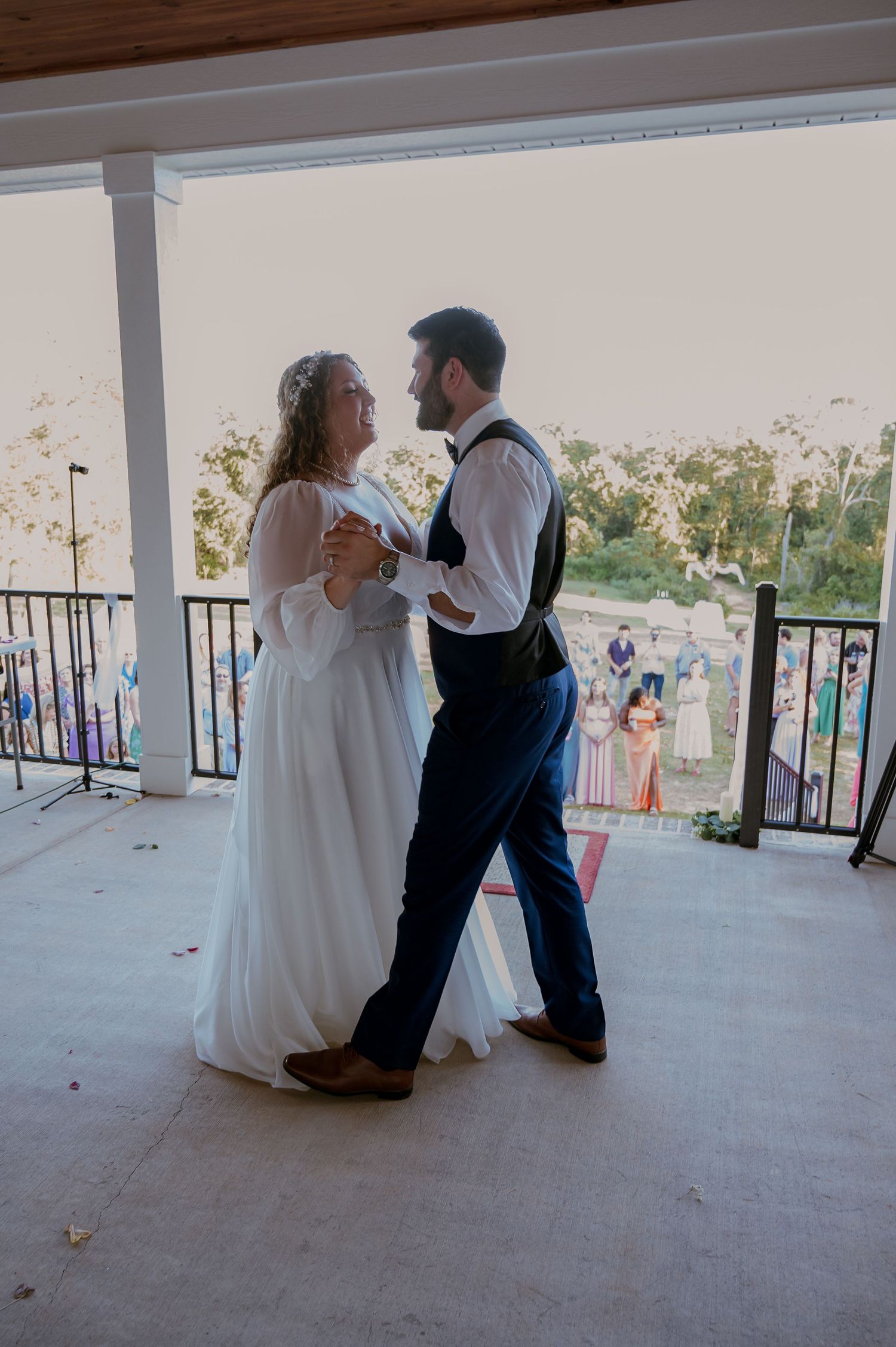 A sequence of dance moves on a covered patio during a wedding celebration.