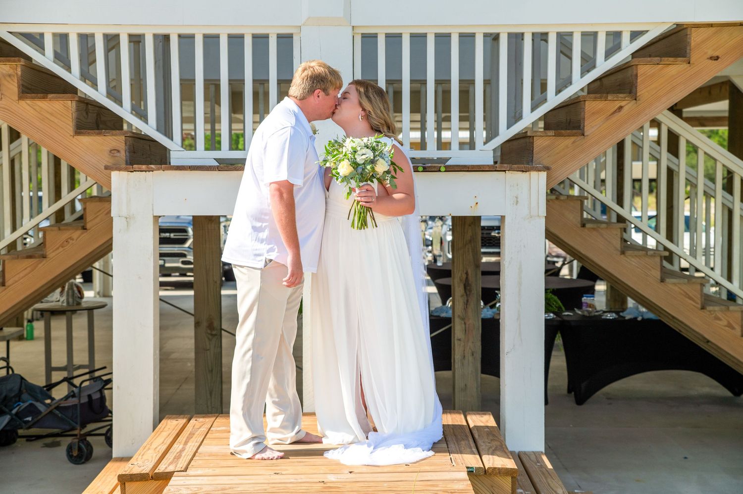 A series of wedding moments captured on a white wooden deck by the water.