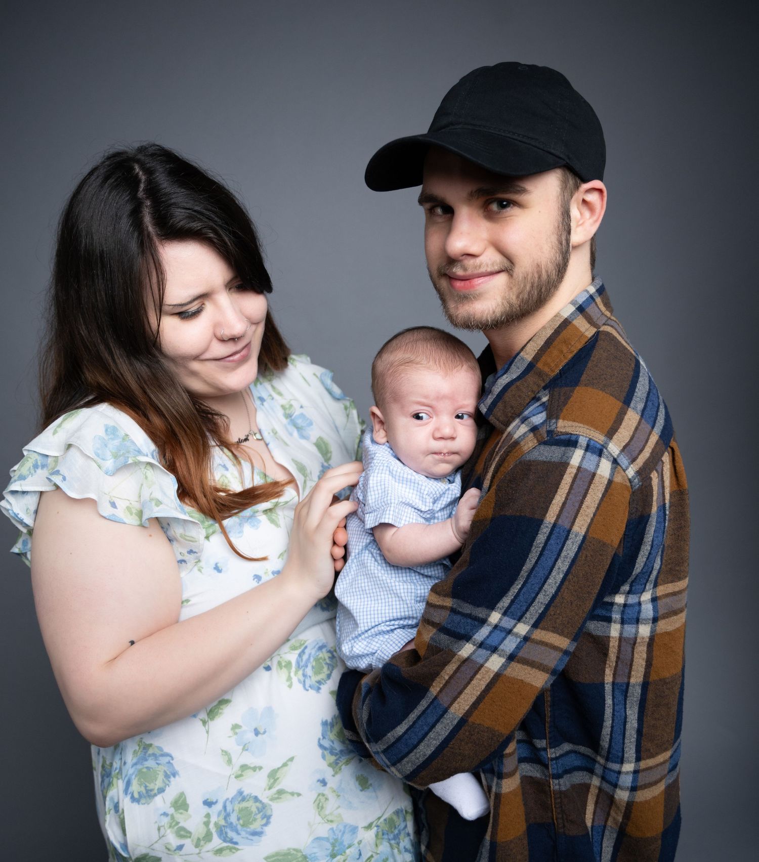 A series of five tender family moments showing parents with their baby in matching floral and plaid outfits.