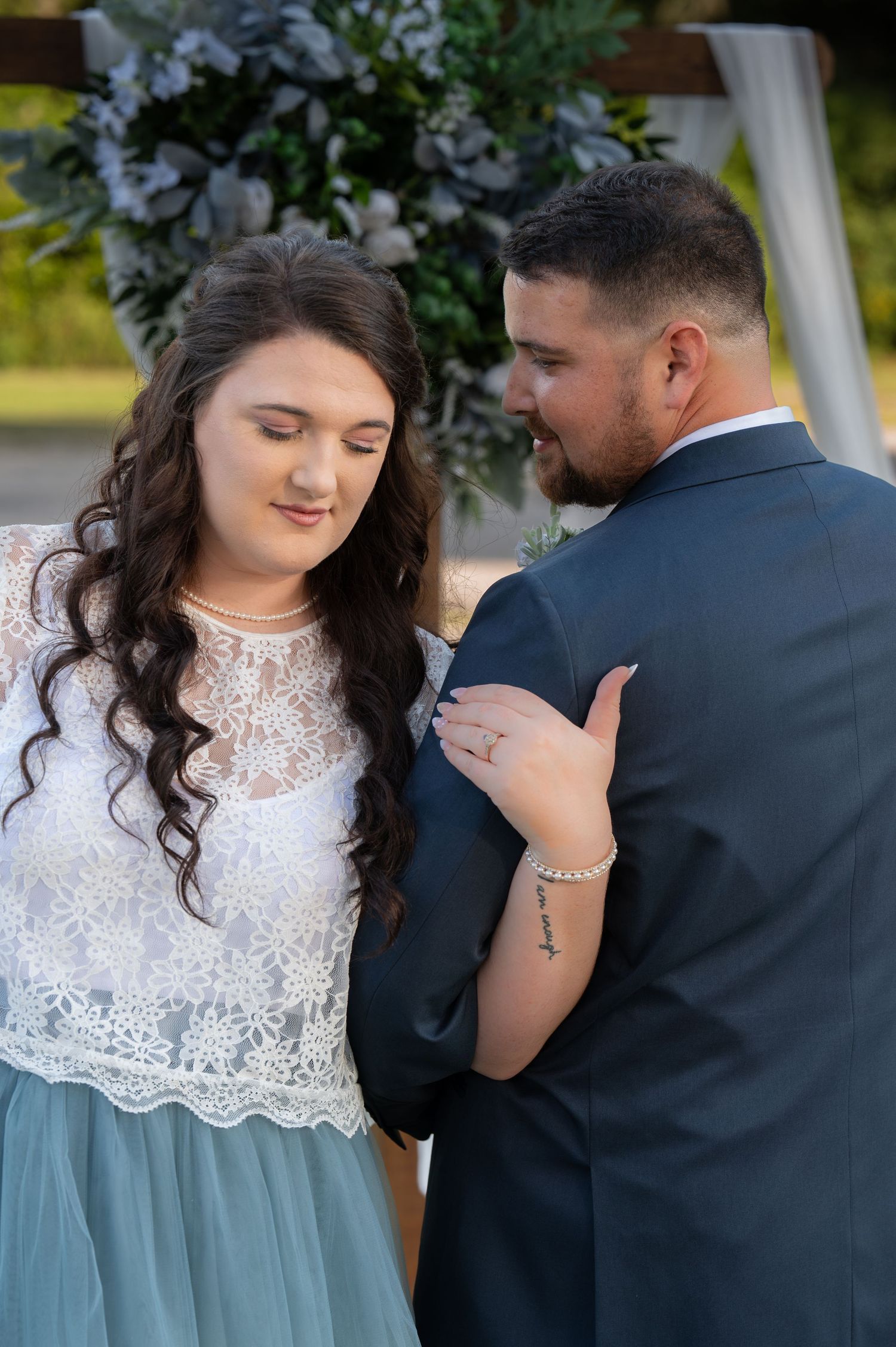 Couple in vintage-inspired attire sharing intimate moment outdoors.