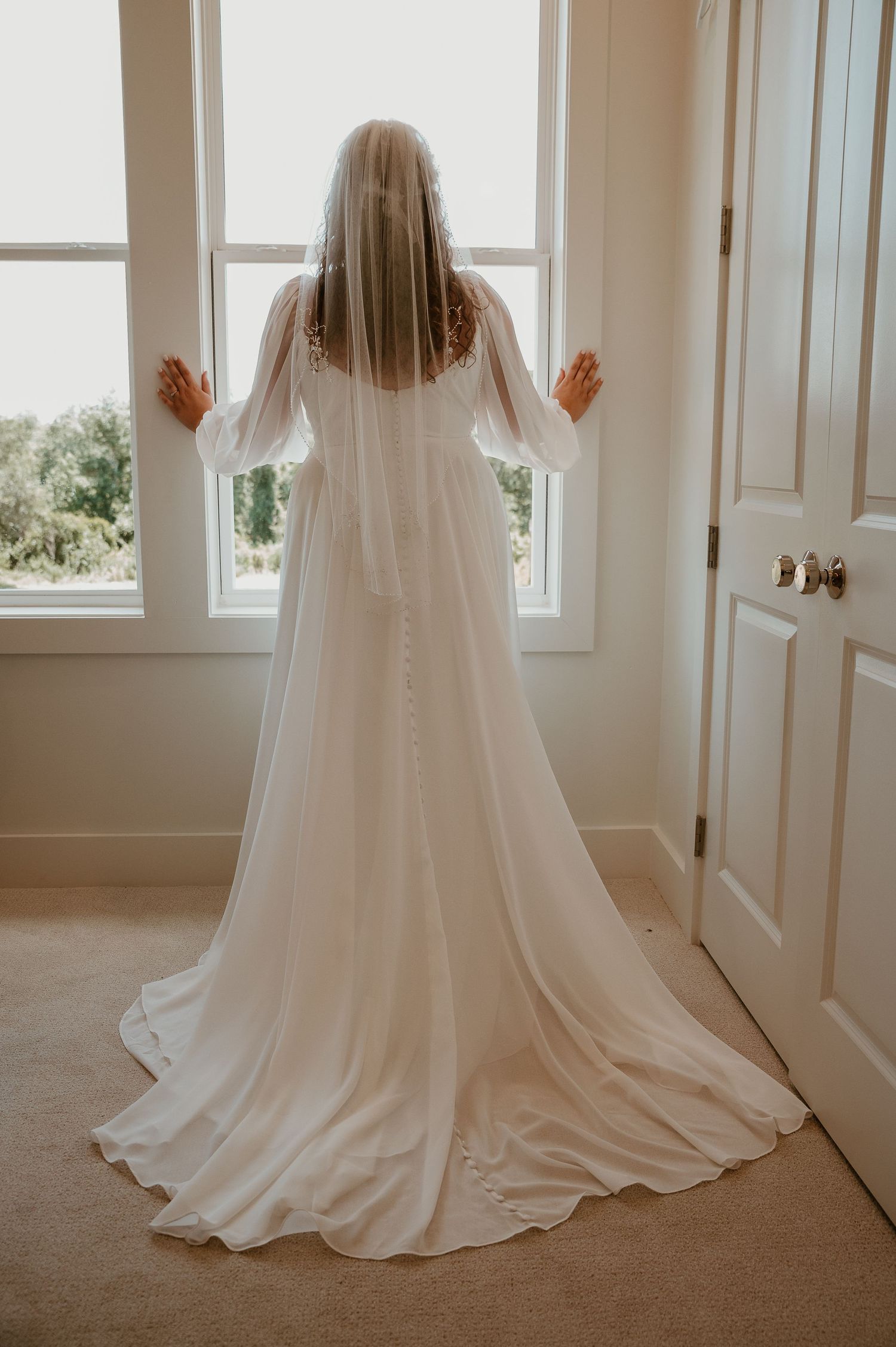 A flowing white wedding dress train photographed in sequence against a bright interior with windows.