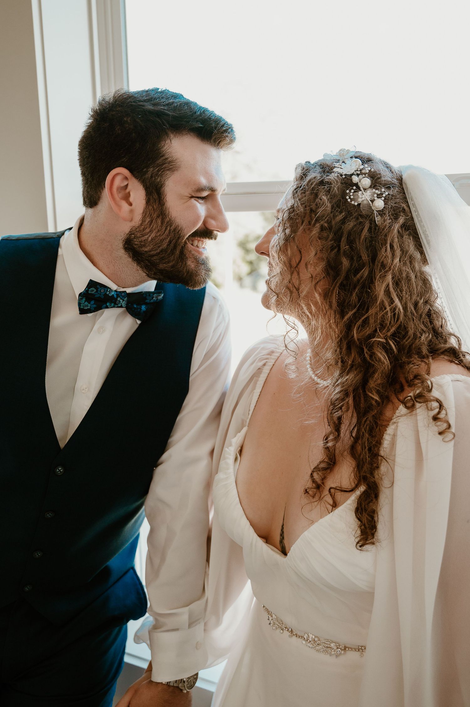 Intimate wedding portrait session with elegant white dress and formal attire.