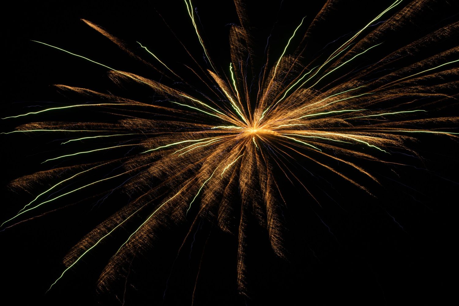 A firework bursting in orange and yellow.