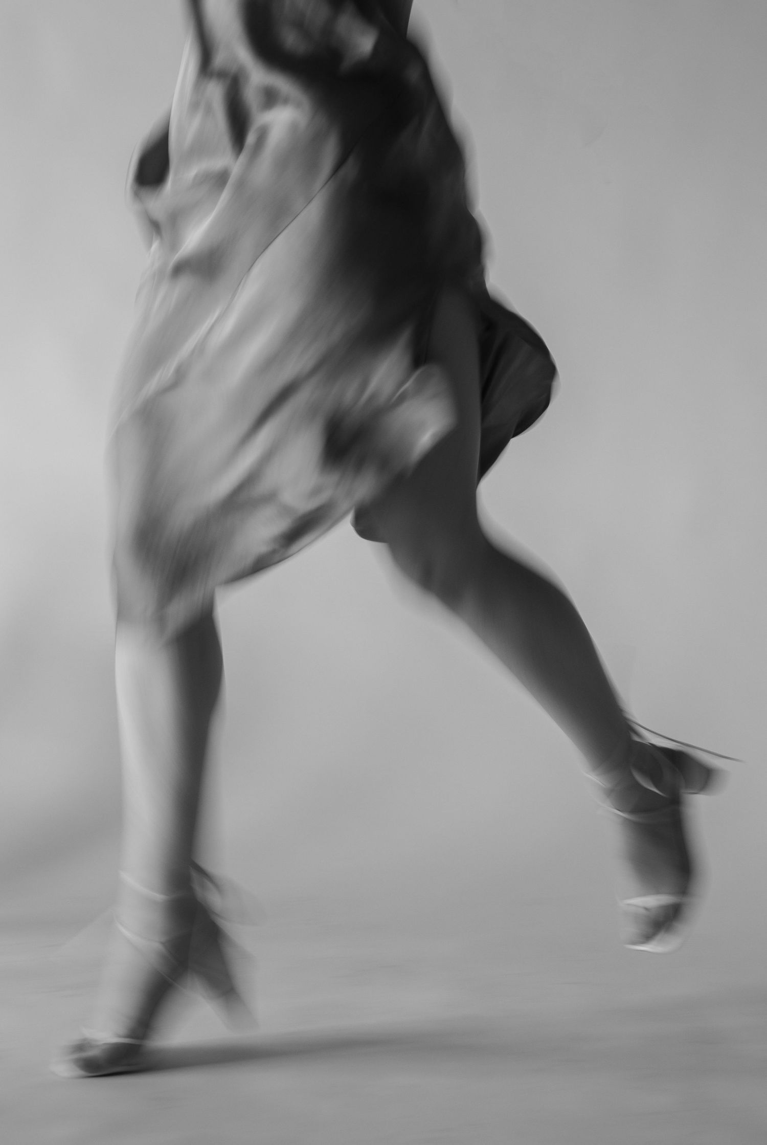 Black and white editorial fashion photo of female model in studio, blurred motion, by Sadie Sanders Photography