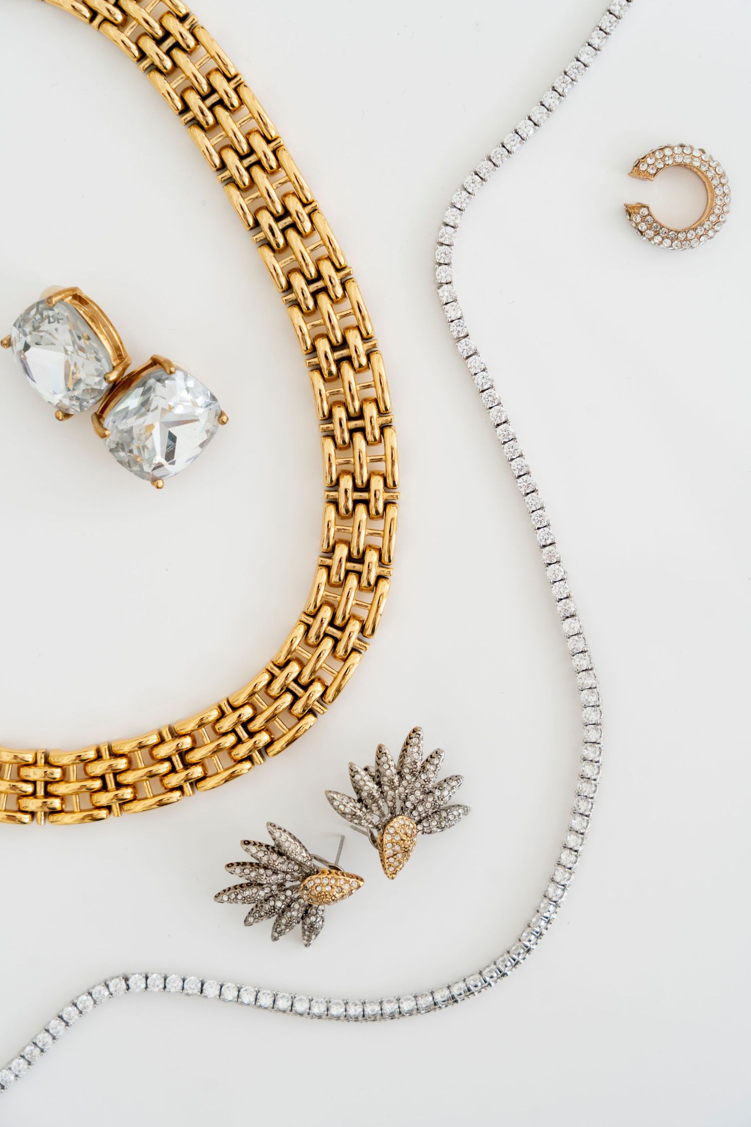 Close-up photograph of jewelry pieces arranged artfully, editorial product styling, photographed by Sadie Sanders Photography