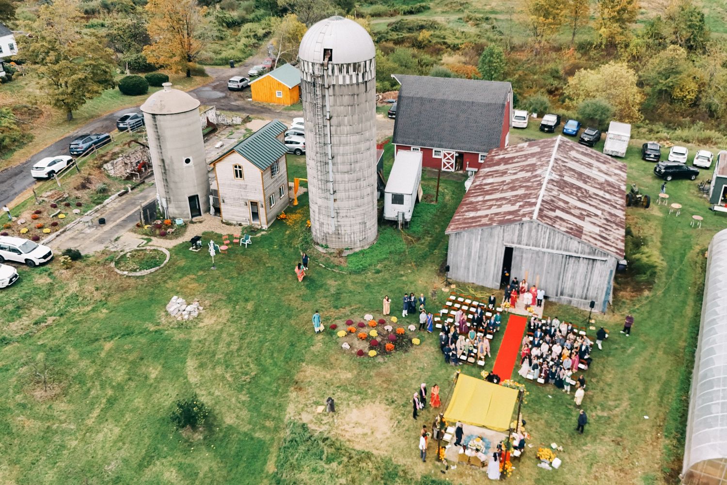 Aerial view of outdoor event venue with tents and scattered crowd.