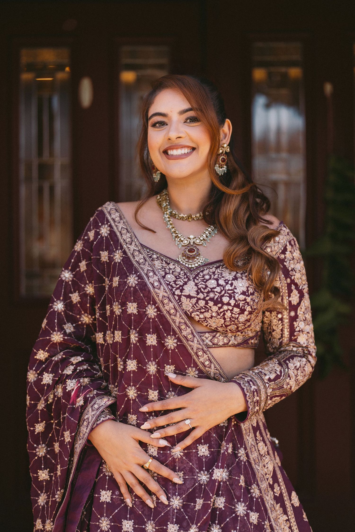 Purple embellished lehenga with intricate embroidery and matching jewelry.