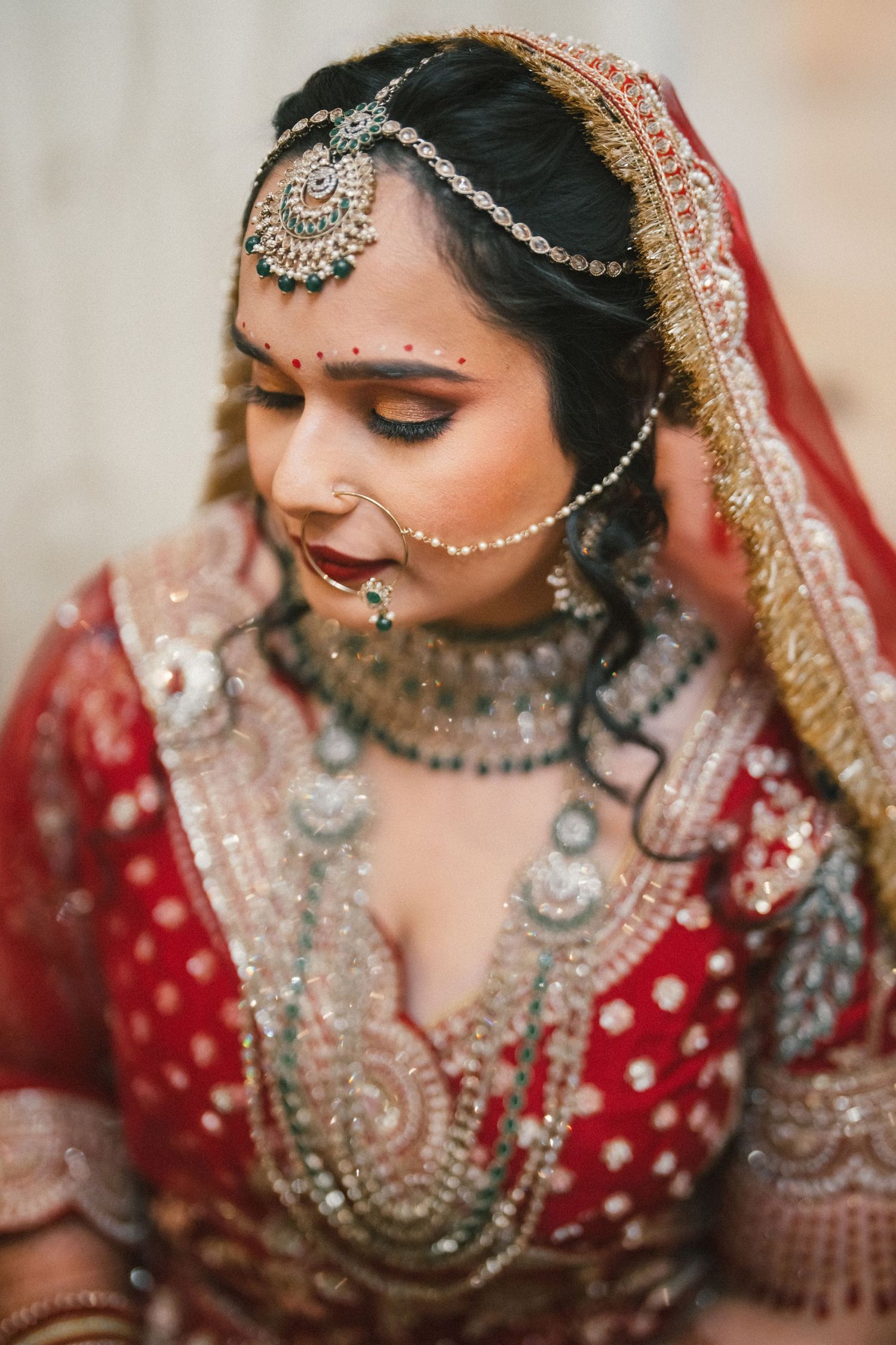Intricate bridal jewelry and makeup details featuring traditional Indian wedding accessories.