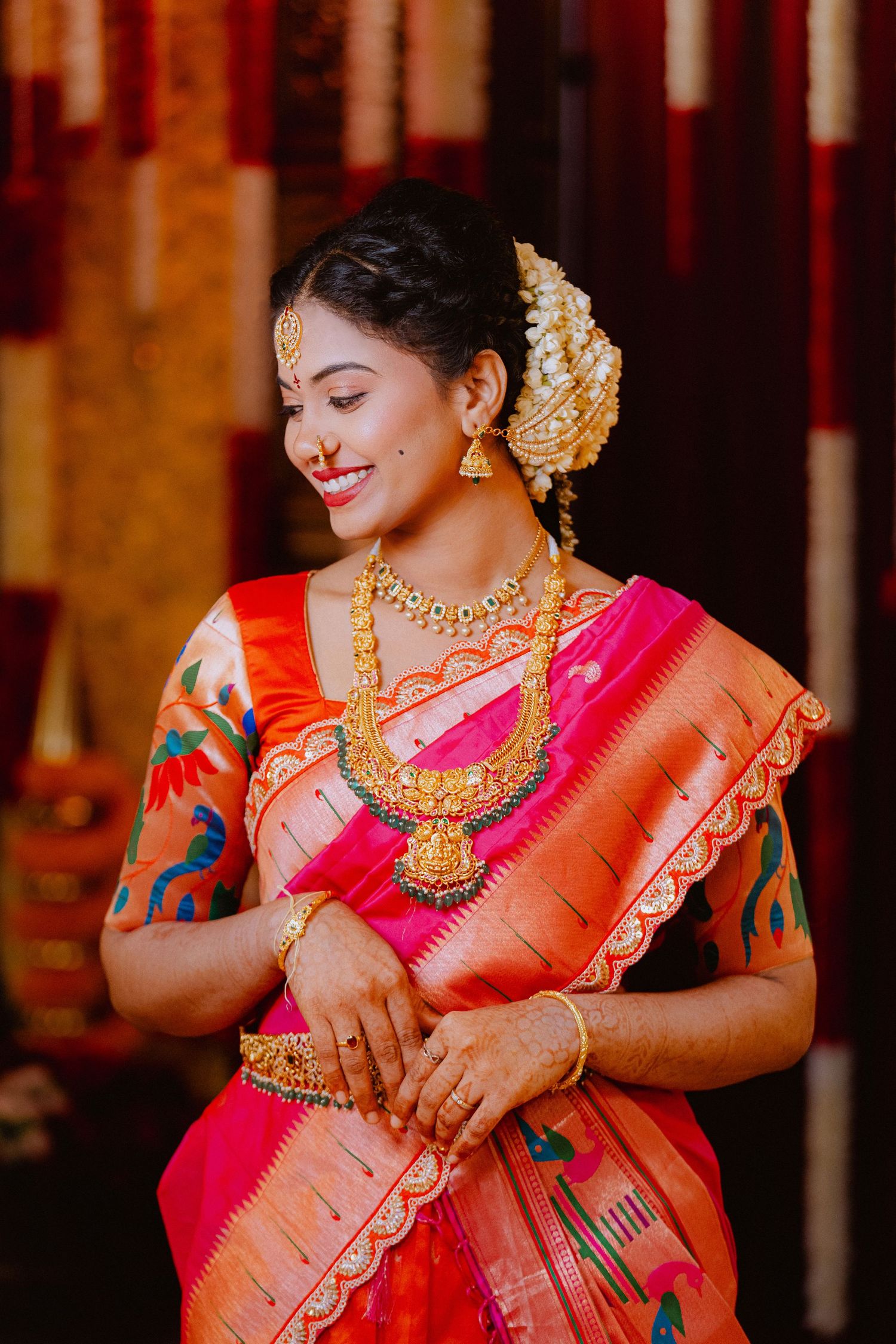 Traditional South Indian bridal look with silk saree and gold temple jewelry.