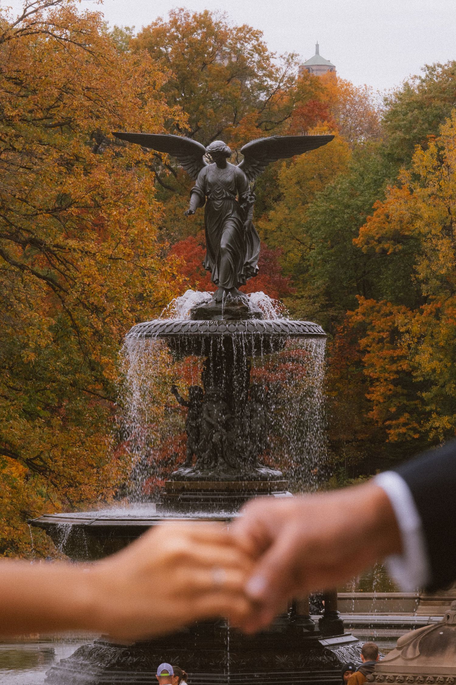 A dramatic panoramic sequence of Bethesda Fountain in Central Park surrounded by autumn foliage and water spray.