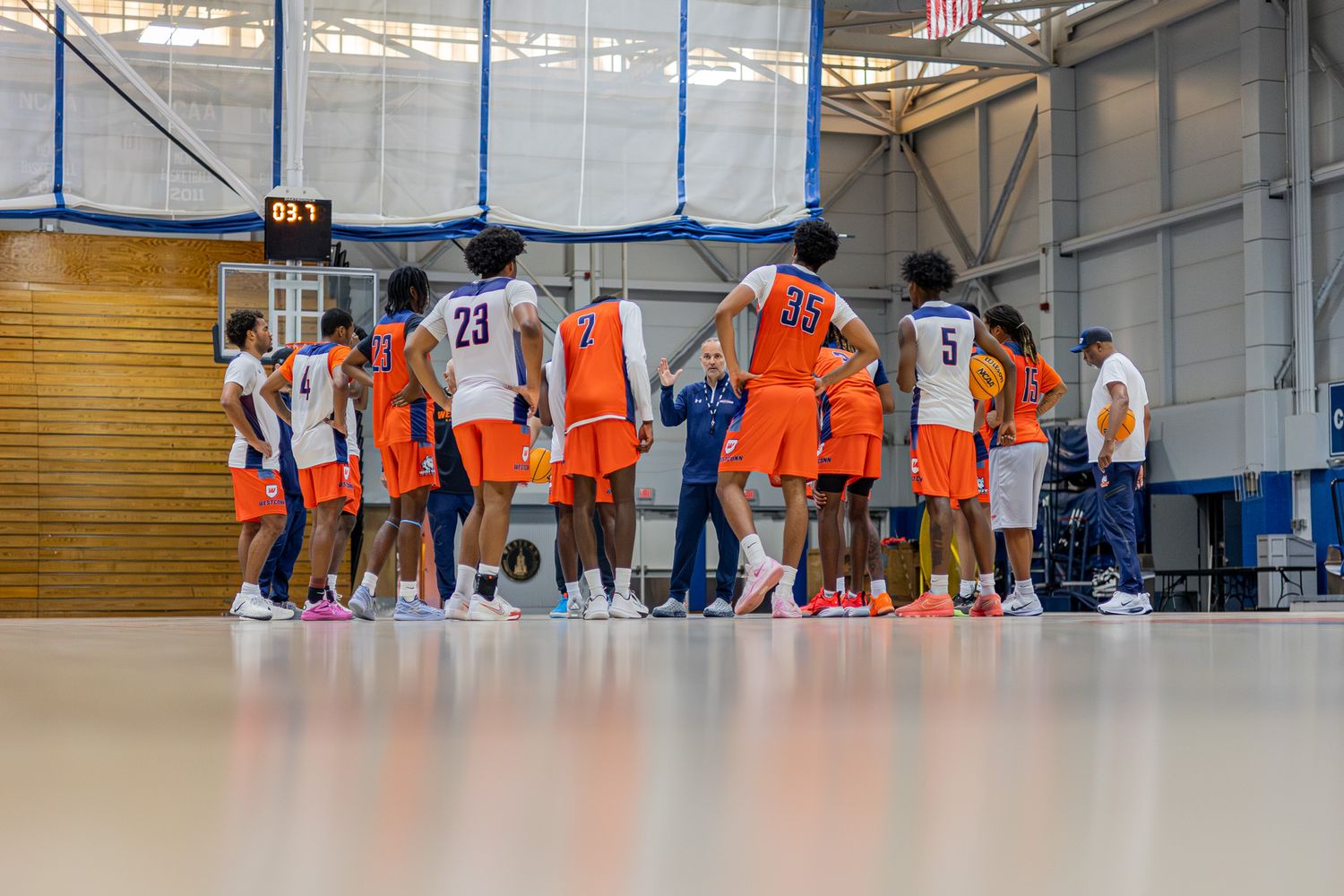 Westconn Mens Basketball Team Huddled