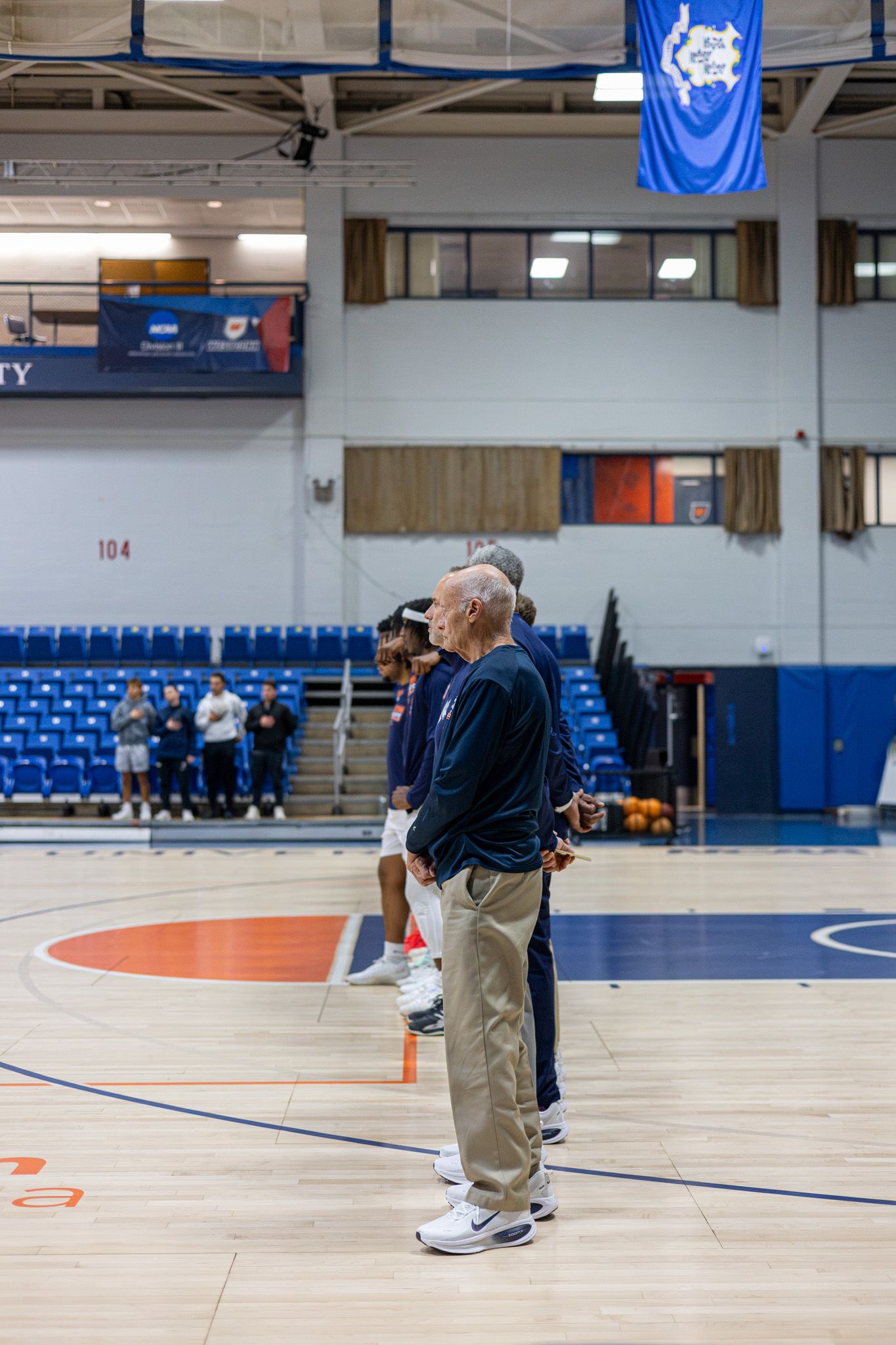 Photo of Westconn Mens Basketball Team lined up for the national anthem.