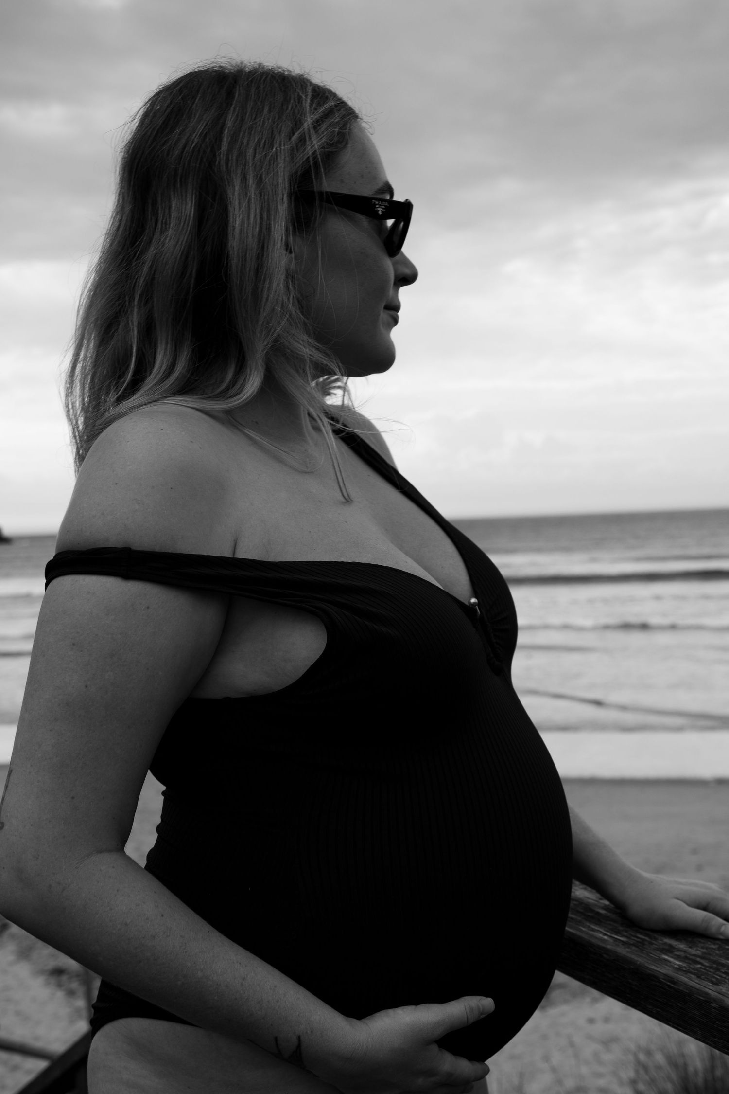 Black and white beach portraits showing silhouette against cloudy sky.