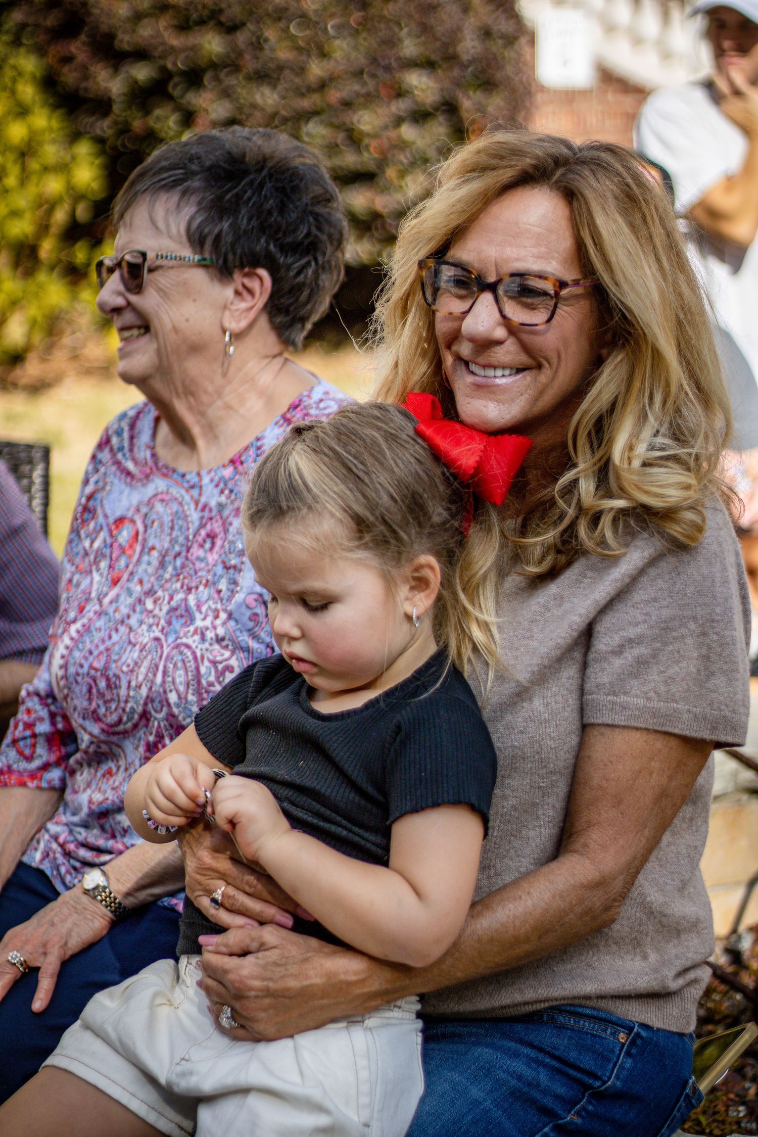 A tender moment shared between people during an outdoor gathering.