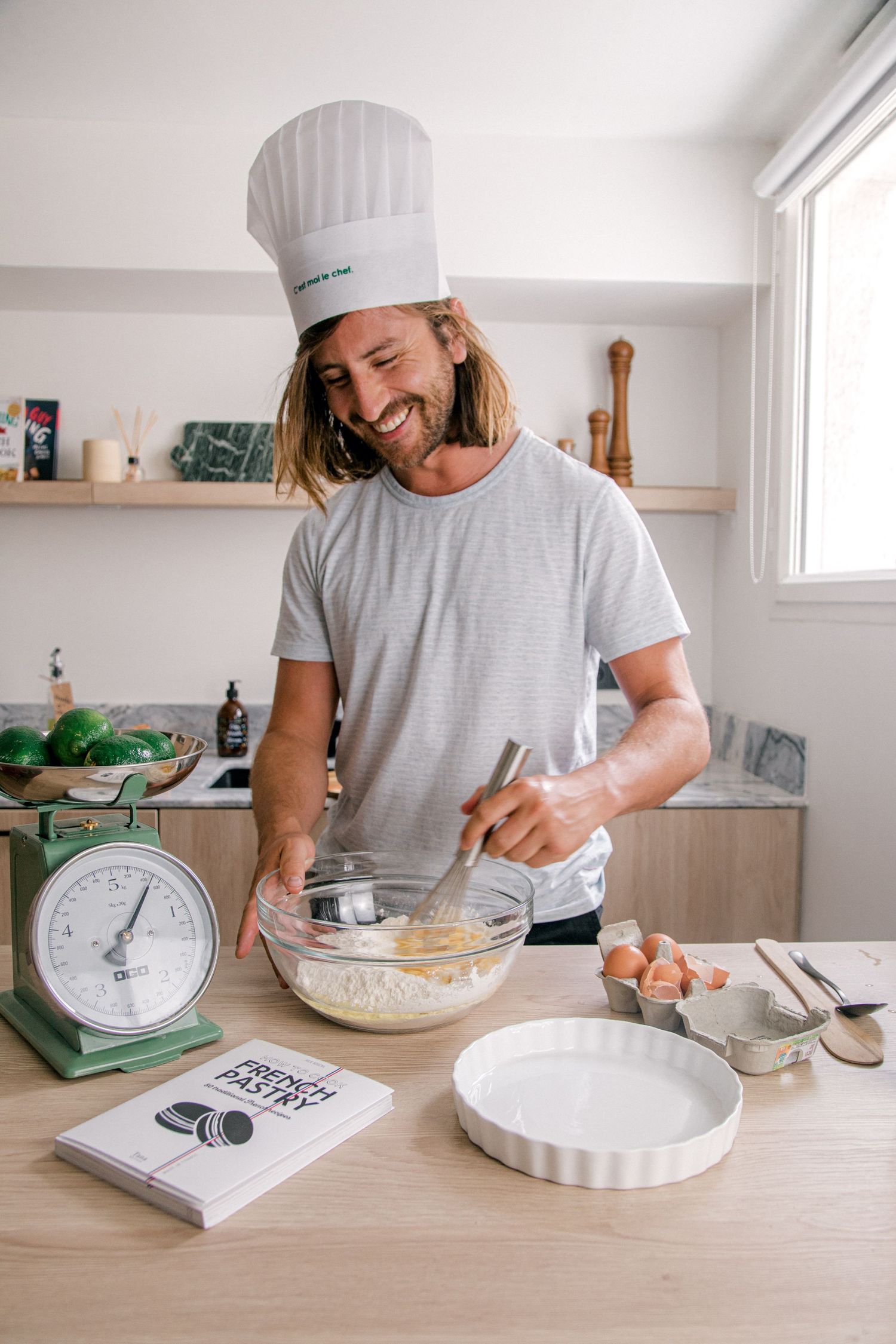 A sequence of photos showing someone in a chef's hat preparing pie dough in a bright white kitchen.