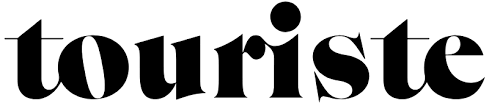 A bold black and white typographic design with the word 'touriste' in stylized lettering against a plain background.