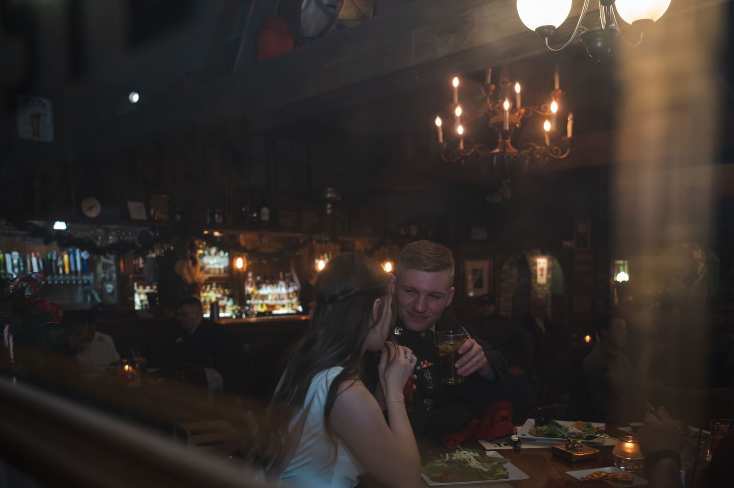 Dark atmospheric scene with glowing lights and candles in an evening setting.