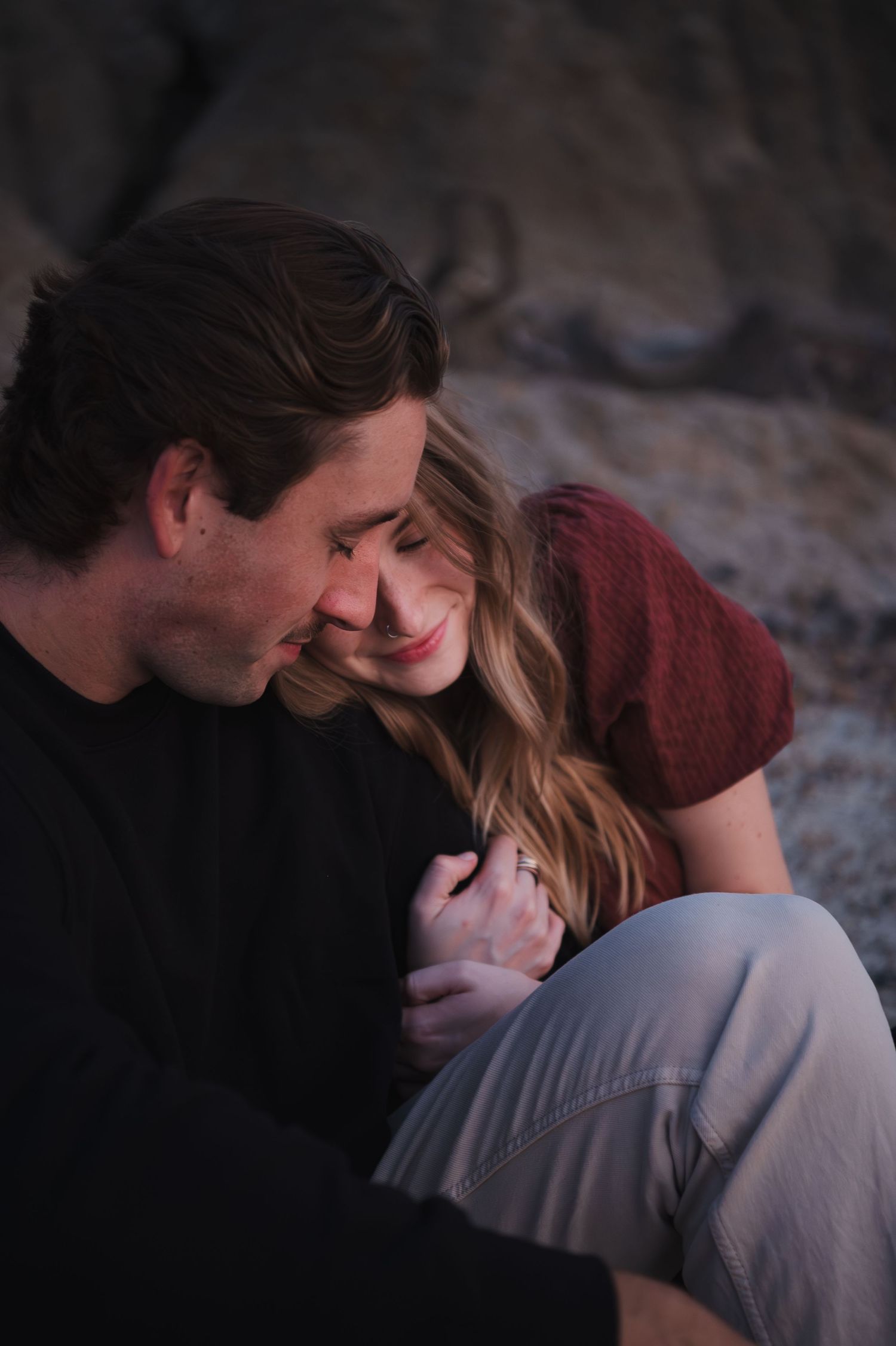 Intimate couple's portrait session at dusk with soft lighting.
