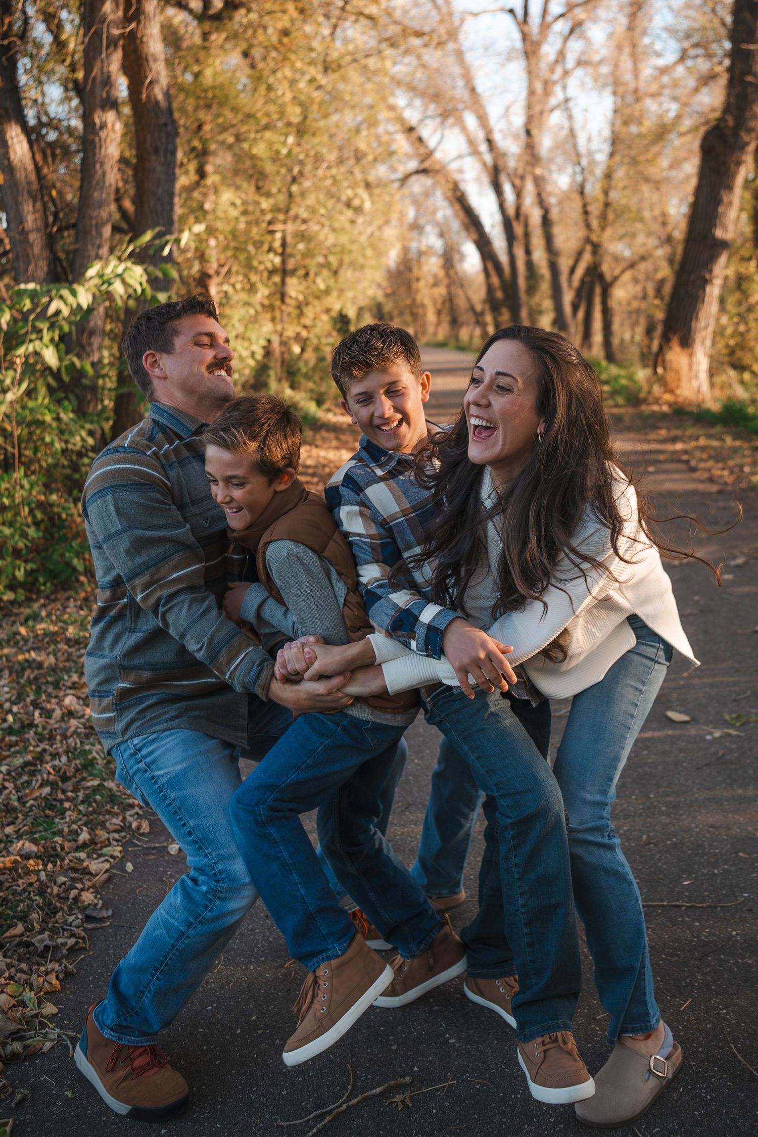 Group playing and laughing together on an autumn path.