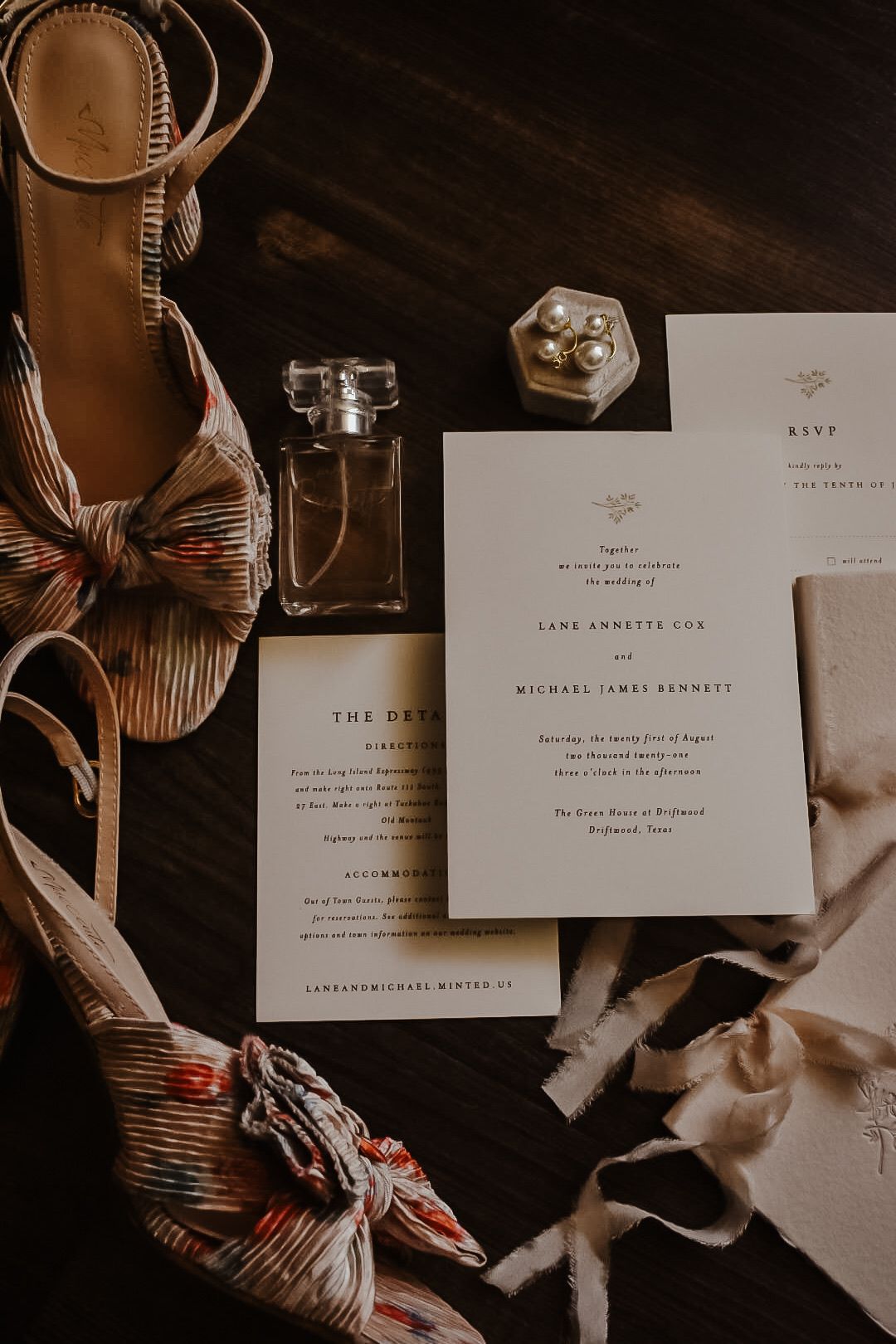 Wedding invitation suite with elegant typography and paper details in warm lighting.